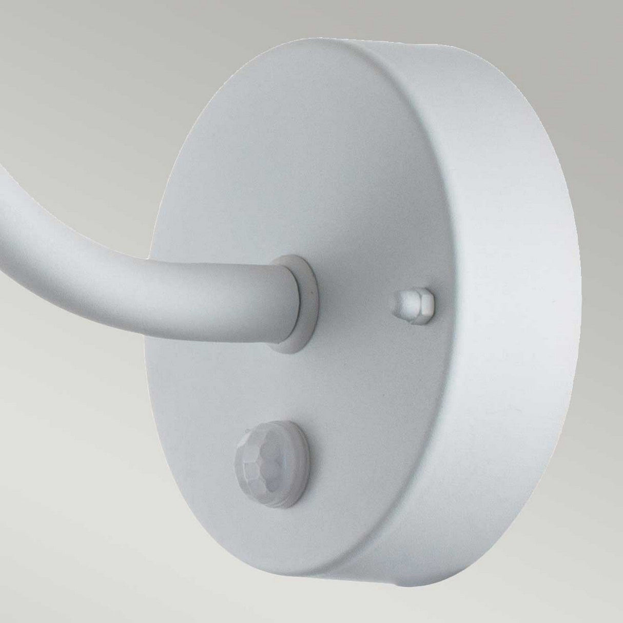 Close-up of the Klampenborg 1 Light Outdoor Wall Light with PIR, showcasing its round design and curved arm in a white finish. The fixture includes a small PIR sensor and a button on its surface, reflecting a touch of Scandinavian design. The background is a gradient of light grey.
