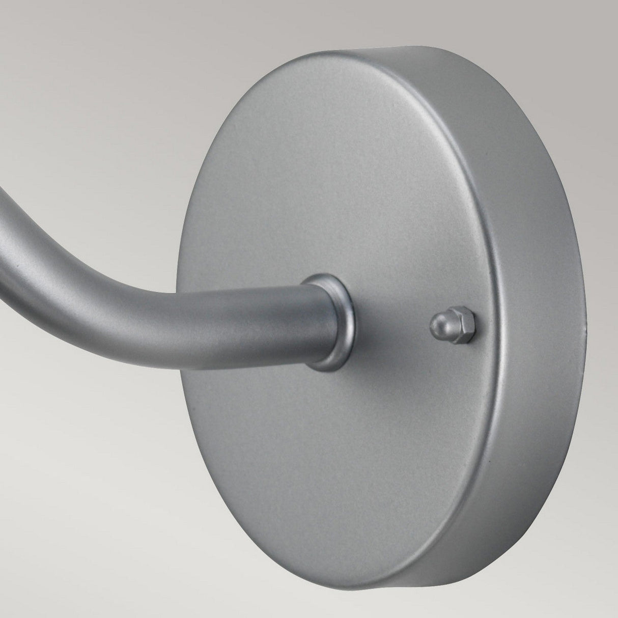 Close-up of a wall-mounted, round, silver stainless steel bracket with a curved arm extending from it against a light gray background. Ideal for the Klampenborg 1 Light Outdoor Wall Light - Silver, with its IP44 rating ensuring durability.
