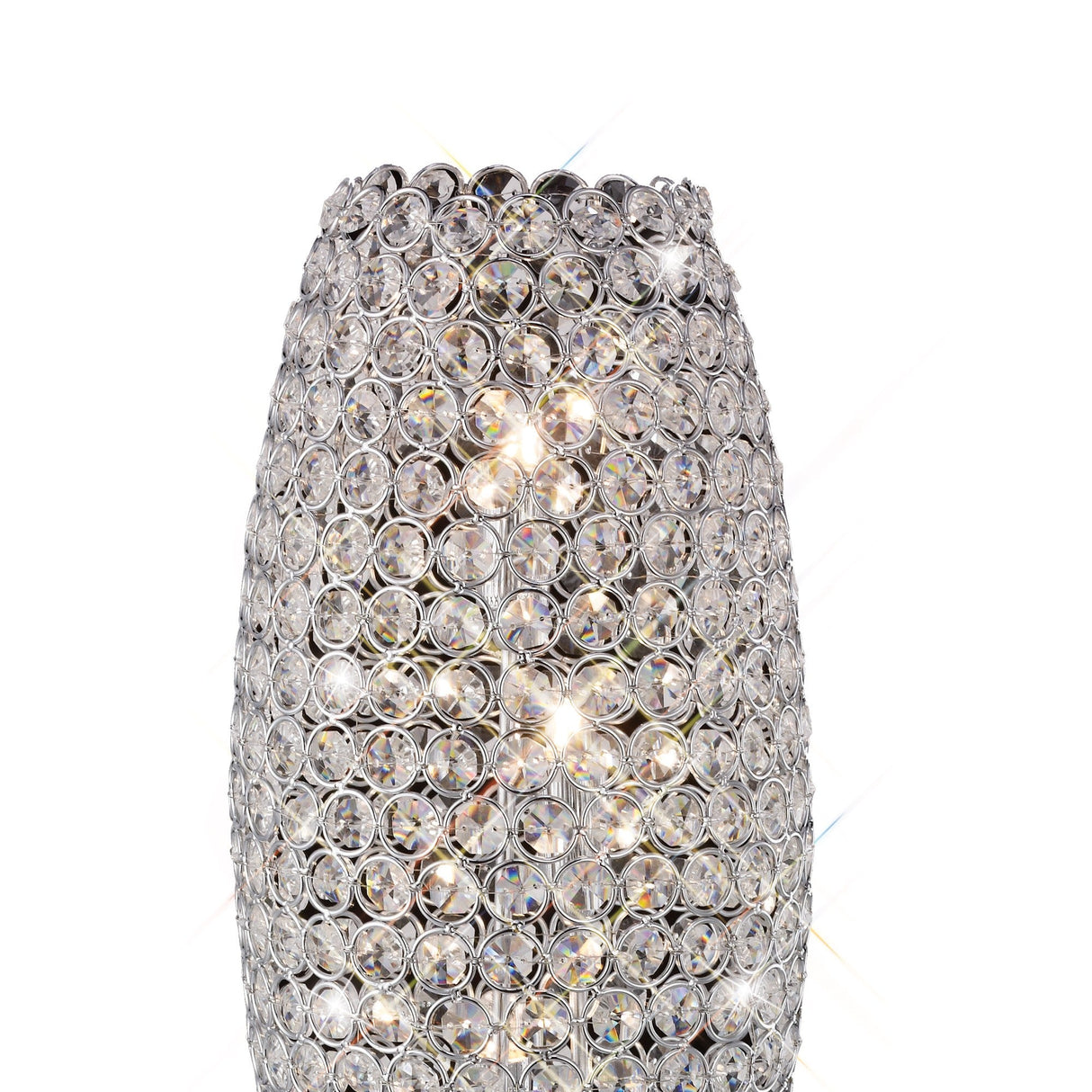 The Kos 3 Light Crystal Table Lamp in polished chrome features a tall, cylindrical design with faceted crystal lattice, casting a brilliant sparkle and serving as a striking modern accent for any room.