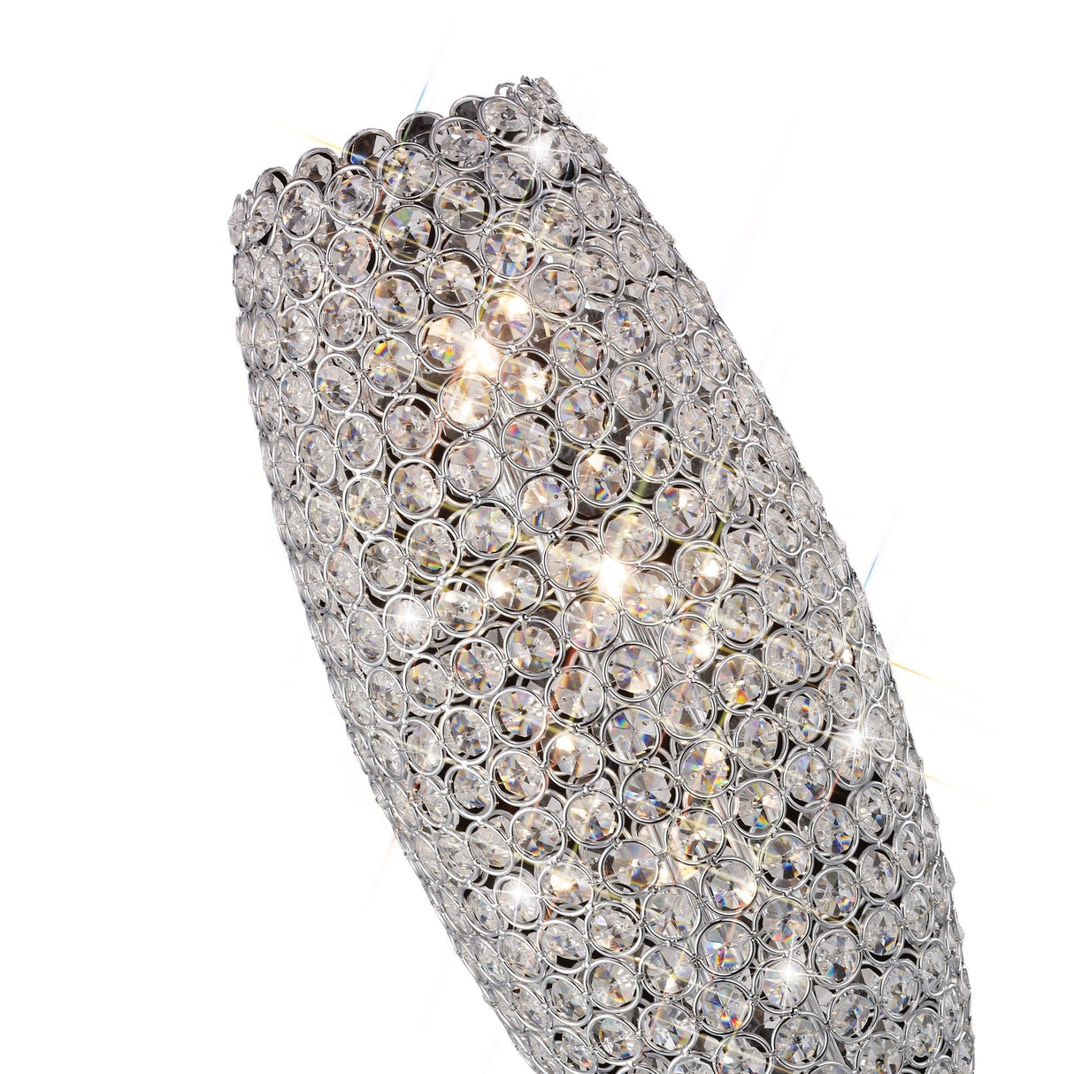 A close-up of the Kos 3 Light Crystal Table Lamp in polished chrome, featuring a tall oval shape adorned with a lattice of clear crystals that reflect and sparkle brilliantly.