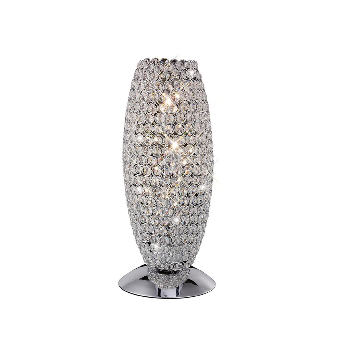 The Kos 3 Light Crystal Table Lamp features a tall, oval-shaped base adorned with sparkling faceted crystals and sits on a polished chrome stand, shown against a white background.
