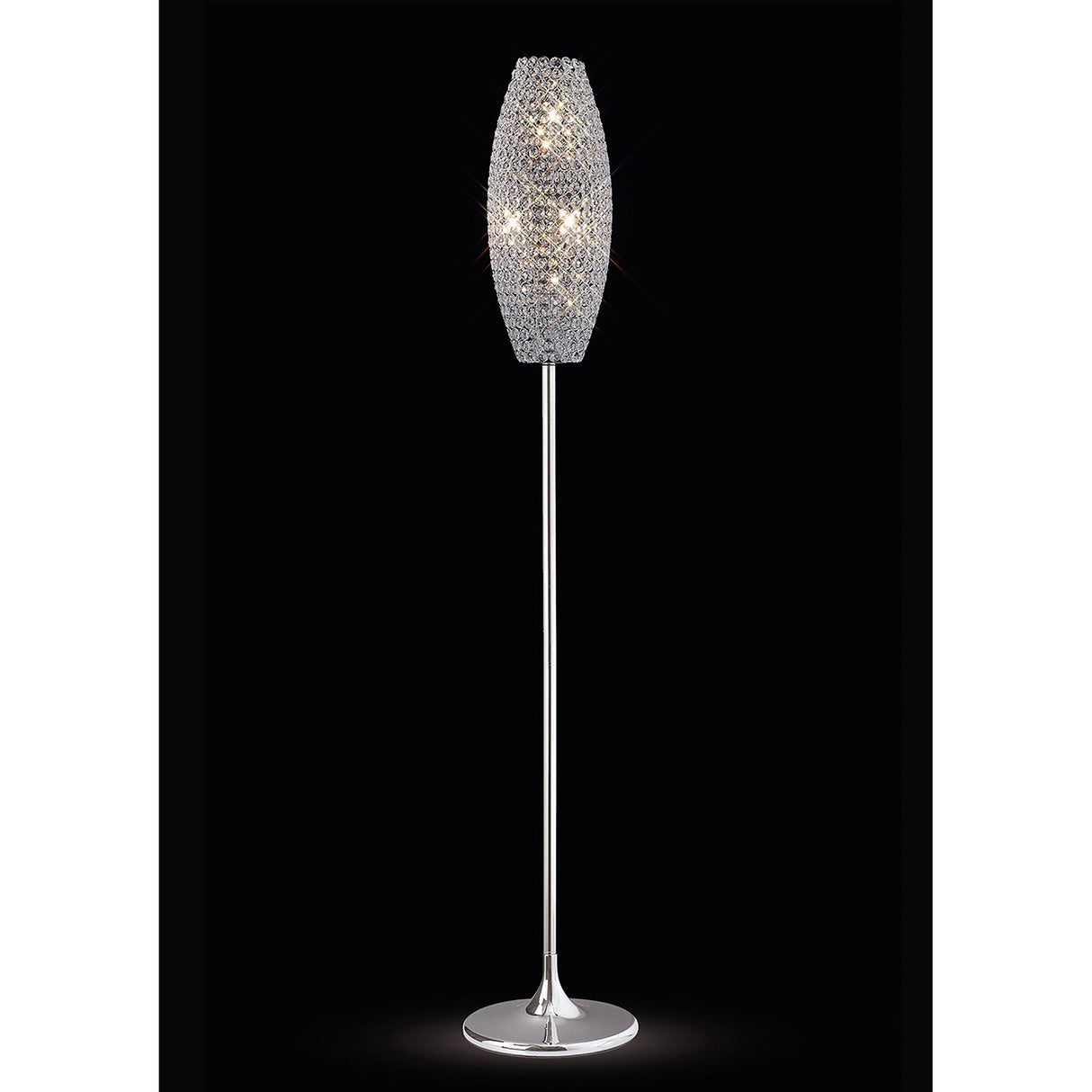 The Kos 4 Light Crystal Floor Lamp features a slender polished chrome stand and a tapered oval lampshade adorned with sparkling crystals, beautifully illuminated against a black background.