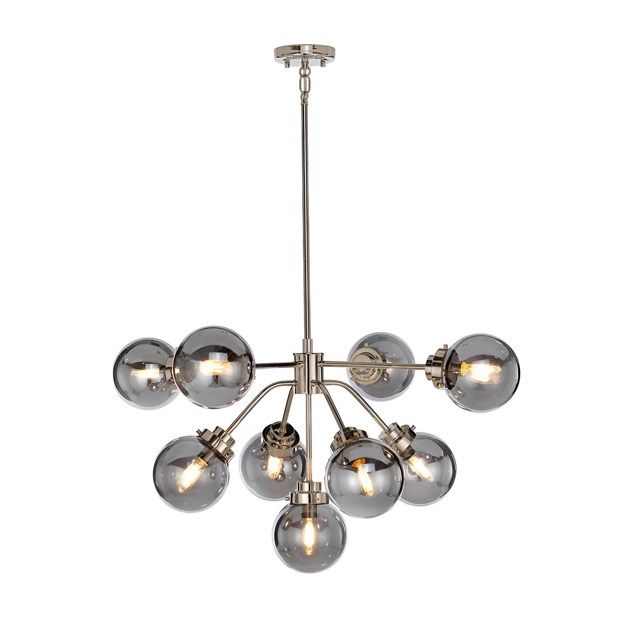 The Kula 9 Light Chandelier - Polished Nickel features a mid-century modern design with a polished nickel finish. Its central metal fixture extends multiple arms, each adorned with a spherical, transparent glass bulb. The nine bulbs are arranged in a starburst pattern, offering an elegant and contemporary ambiance.