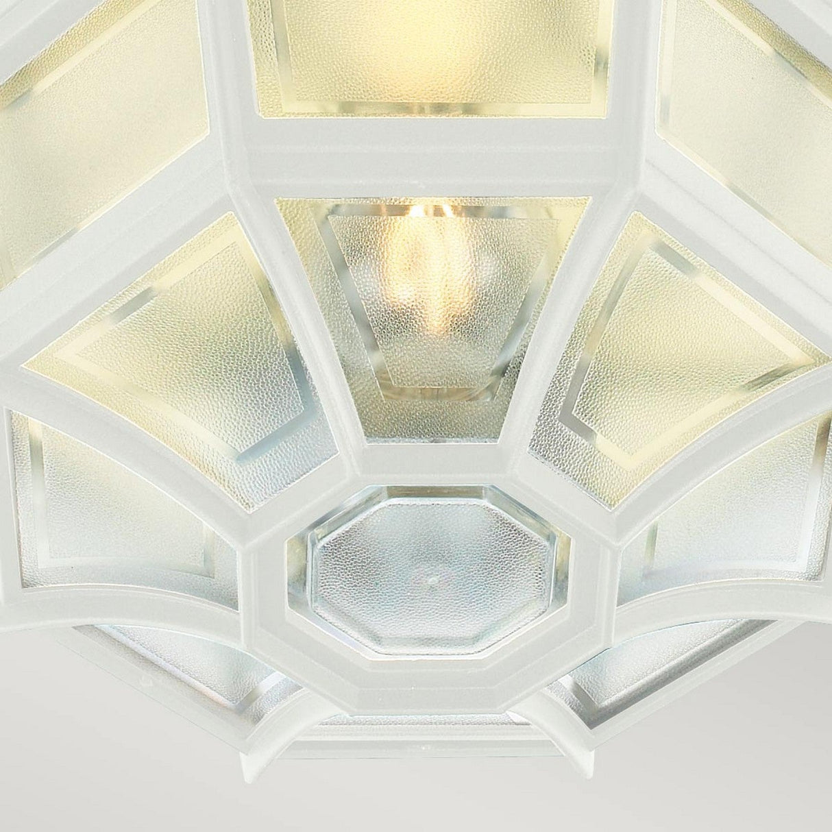 Close-up of the Latina Outdoor 1 Light Ceiling Light in white, featuring a durable cast aluminum frame and frosted glass panels. The light inside radiates a warm glow through the textured glass.