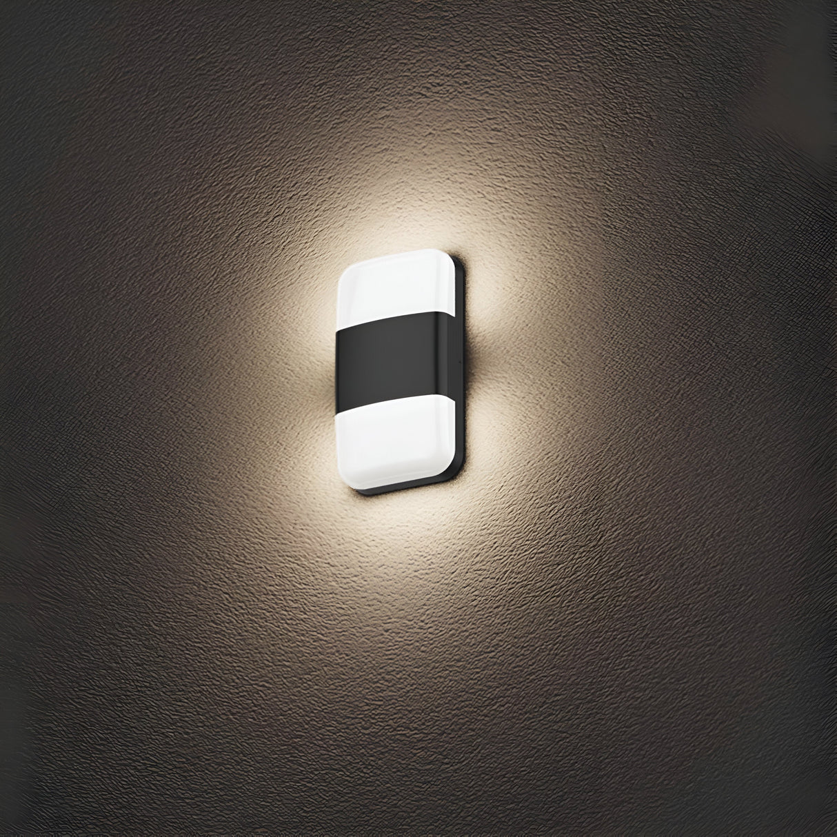 The Lars LED Outdoor Wall Light in black features a sleek, modern design with a rectangular shape and a black horizontal band. Its IP65 rating guarantees durability, while the warm glow it casts on textured brown walls adds a cozy ambiance that emphasizes its contemporary style.