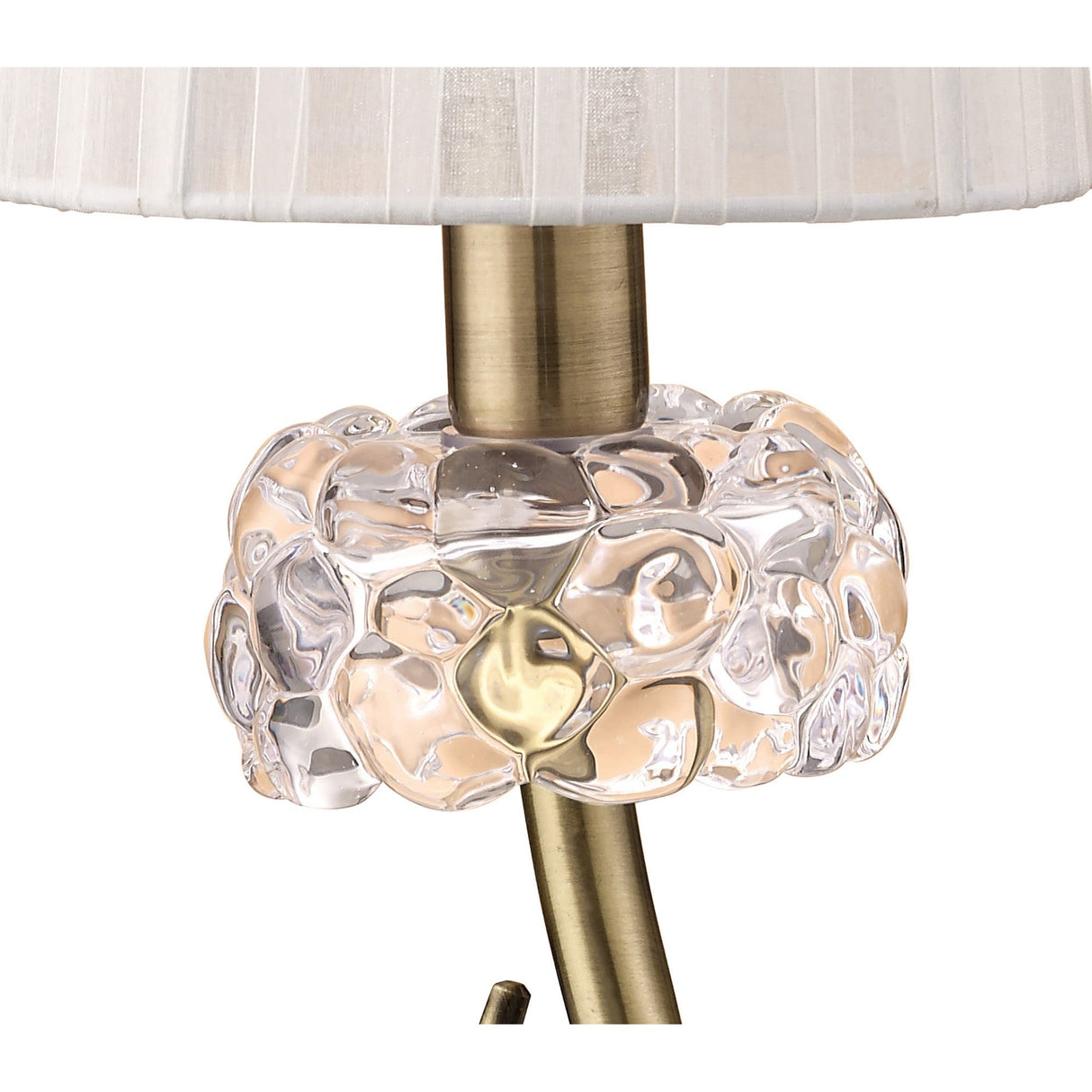 Close-up of the Loewe Small 1 Light Table Lamp in antique brass, showcasing clear textured glass bubbles at the base and a white fabric shade.