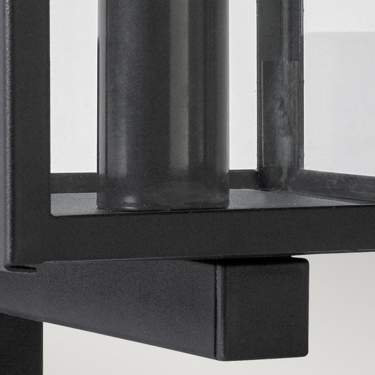 Close-up of the Lofoten Outdoor 1 Light Wall Light in black, highlighting its minimalist design with clean lines and transparent panels. This modern wall light features a rectangular frame that reveals its inner structure and is IP44 rated to withstand diverse weather conditions.