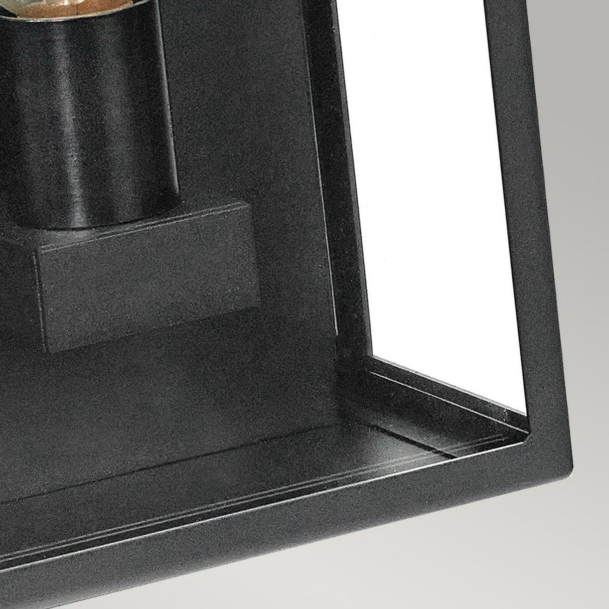 Close-up of the Lofoten Outdoor 1 Light Half Lantern in black, featuring a cylindrical design inside a sleek black frame. The modern aesthetic with right angles and a glossy finish is displayed against a neutral gray background, similar to outdoor lighting with an IP44 rating.