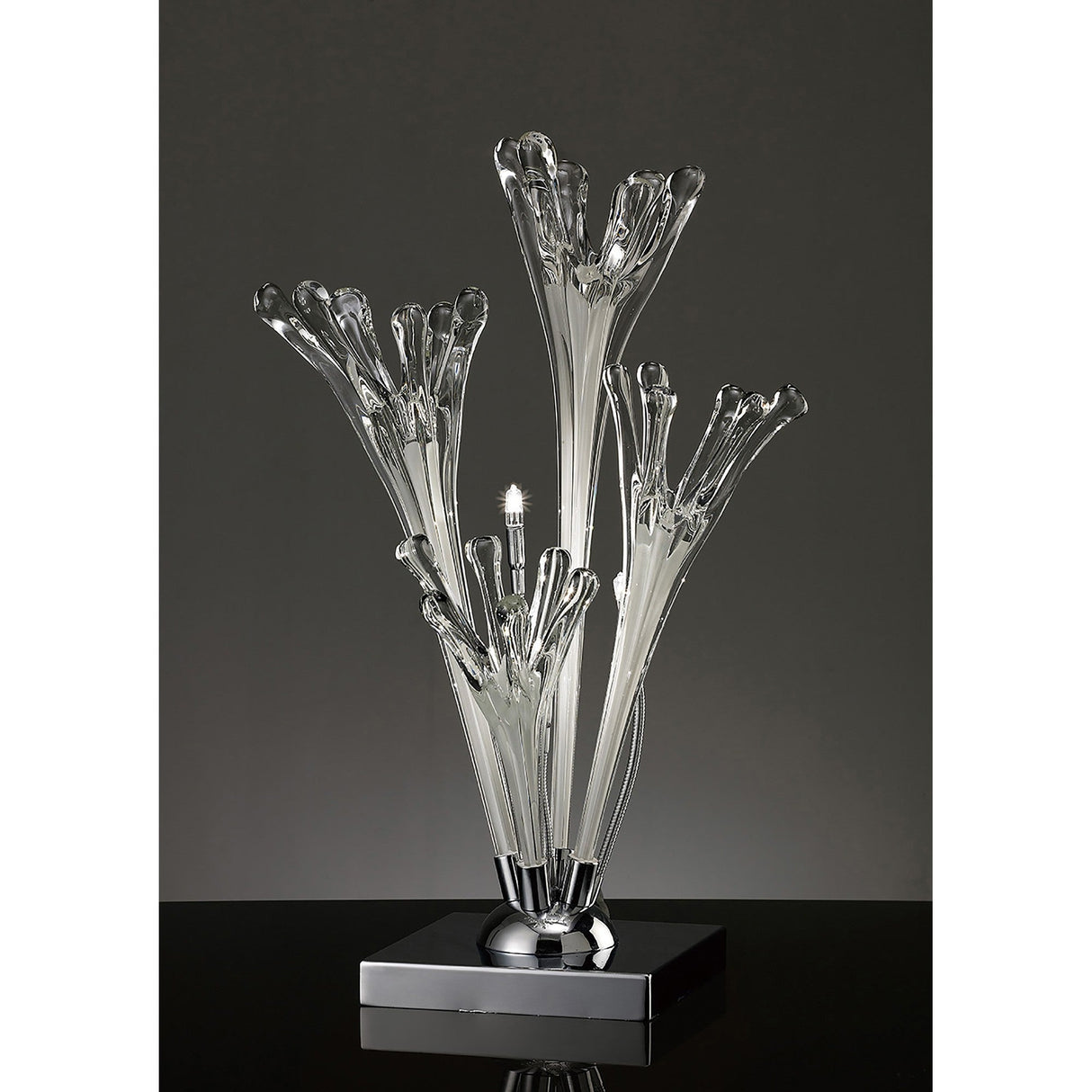 The Love 3 Light Table Lamp features white, hand-crafted glass branches reminiscent of abstract flowers on a polished chrome base, beautifully illuminated against a dark background.