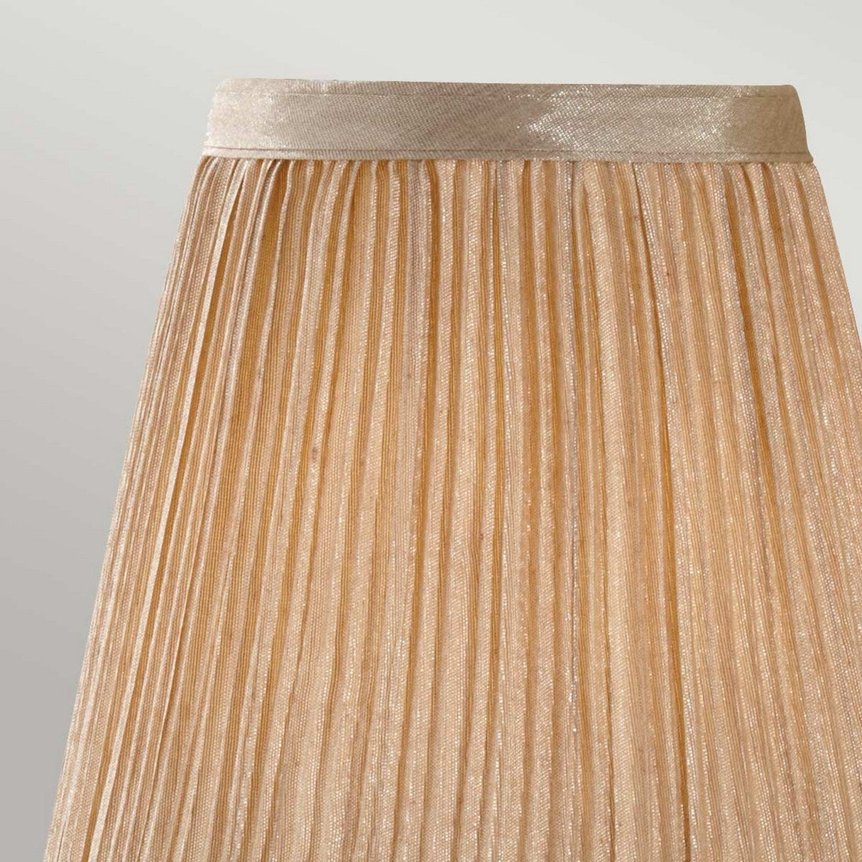 The Clip Shades Mushroom Pleated Gold Chiffon Candle Shade is shown against a light gray background. The luxurious chiffon fabric features a subtle metallic sheen, adding sparkle to the pleated design.