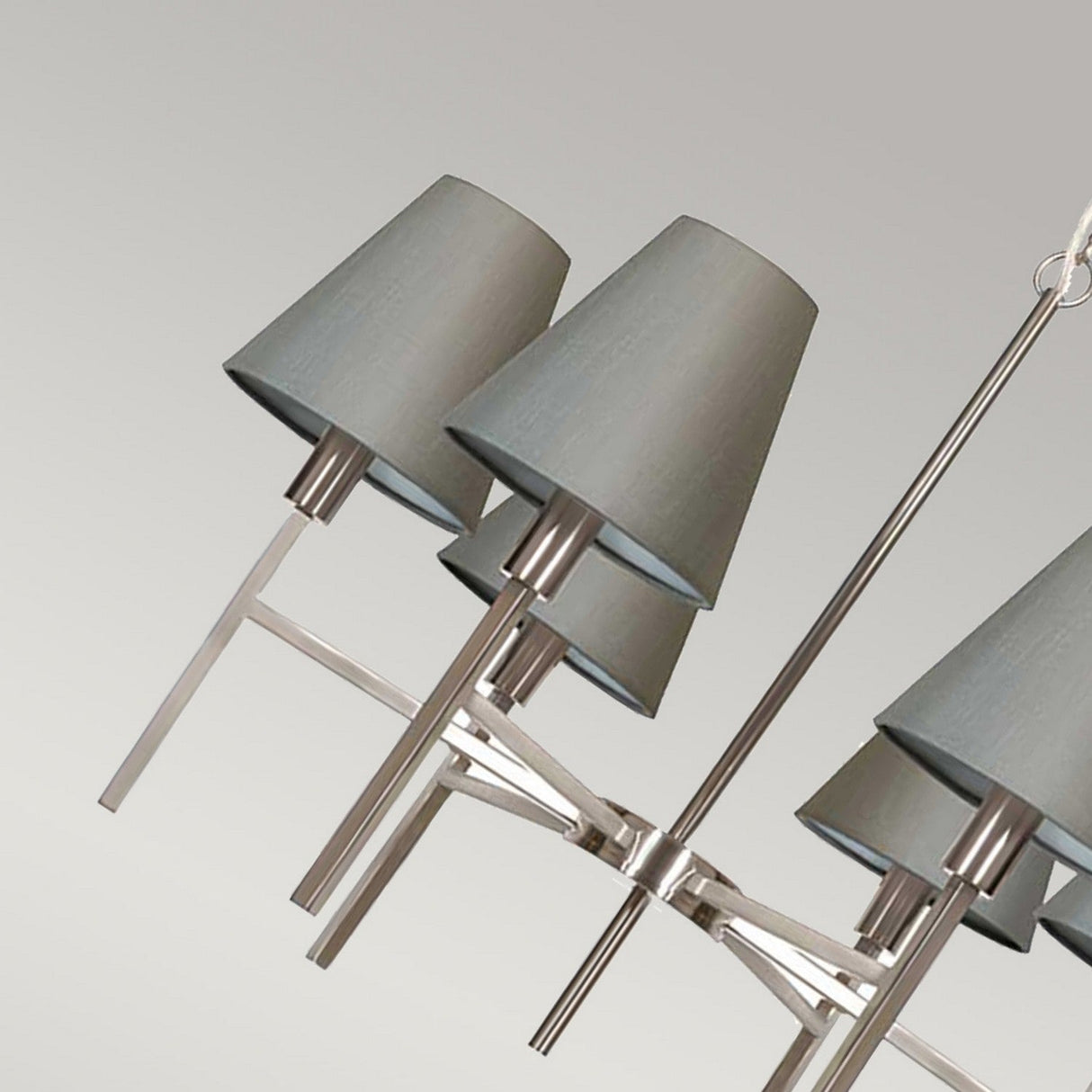 Introducing the Lucerne 6 Light Chandelier - Brushed Nickel With Grey Shade, featuring elegant grey fabric shades and a sleek brushed nickel frame. This modern chandelier adds a sophisticated touch against any neutral background, making it a perfect centerpiece for contemporary interiors.