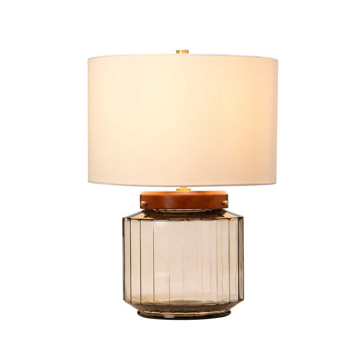 Introducing the Luga Table Lamp in Aged Brass: This contemporary table lamp showcases a cylindrical fabric shade that emits a soft, warm glow. Its base is thoughtfully designed using recycled glass, topped with a rounded, glossy wooden accent, making it an elegant choice for any modern interior.