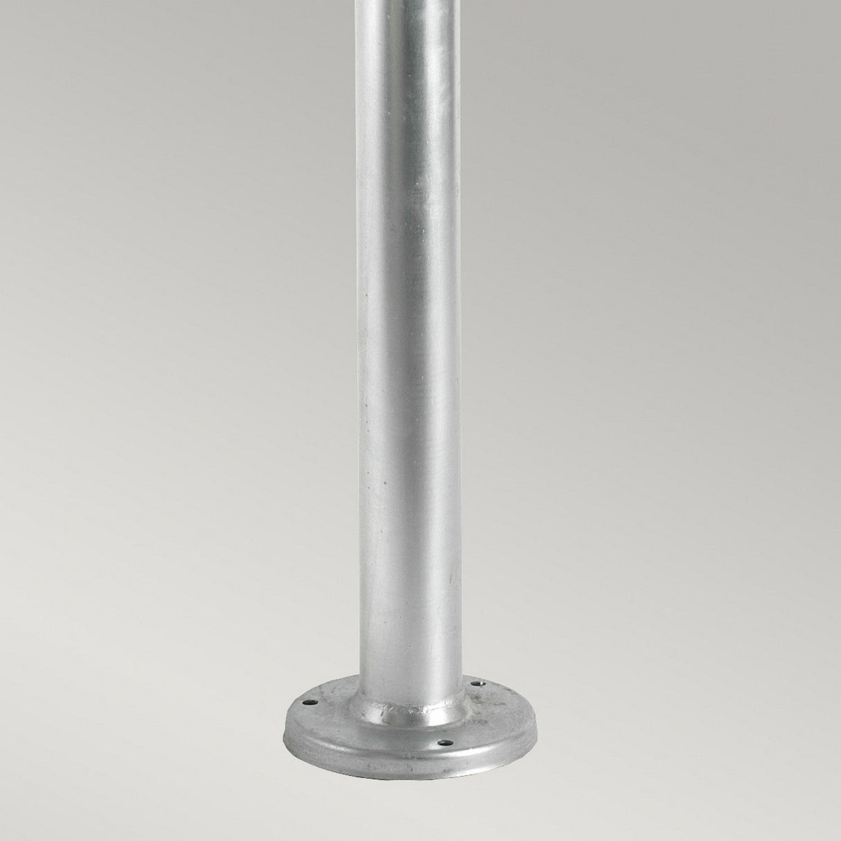 Against a plain gray background stands the Lund 1 Light Lamp Post - Silver, a galvanized steel pole with a round base designed for installation on flat surfaces, making it an ideal choice for outdoor lighting solutions.