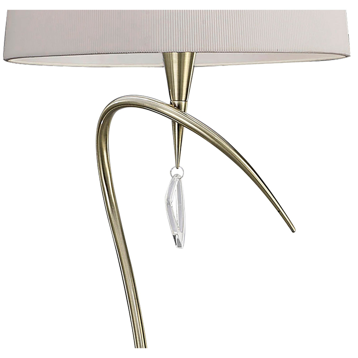 A close-up of the Mara 4 Light Floor Lamp in Antique Brass with an Ivory White Shade shows its curved stem and elegant charm—ideal for enhancing any space.