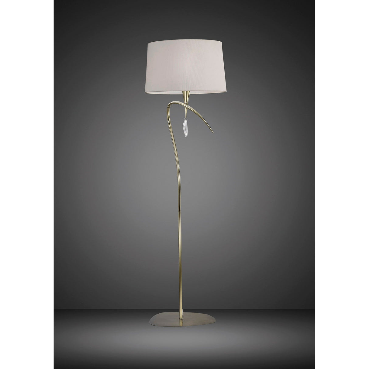 The Mara 4 Light Floor Lamp features an antique brass finish with a slim, curved gold stand, ivory white fabric shade, leaf-shaped accent, and a round flat base. Shown against a dark gradient background.