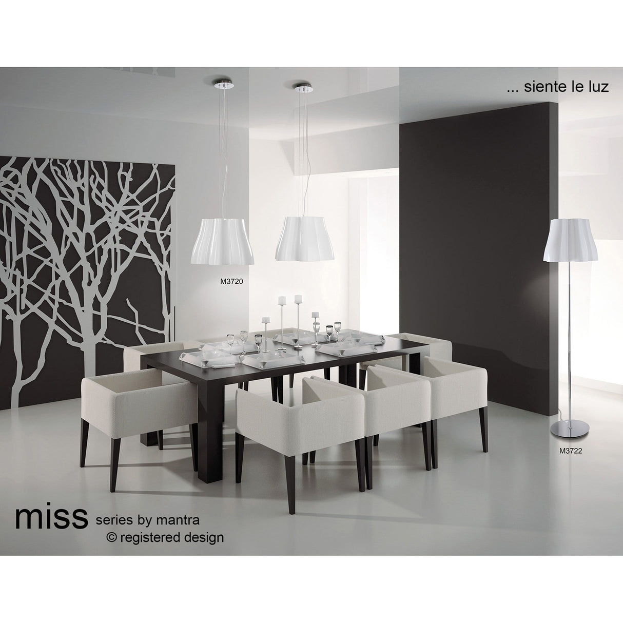 Modern dining room featuring a dark rectangular table, six white cushioned chairs, two gloss white pendant lights above the table, and a Miss 3 Light Floor Lamp in gloss white & polished chrome. Minimalist black-and-white design with branch pattern wall.