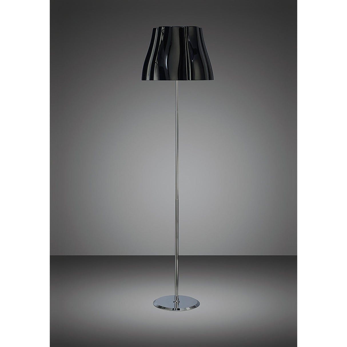 The Miss 3 Light Floor Lamp features a gloss black, wavy shade on a slim polished chrome pole with a round base, shown against a gray gradient backdrop.