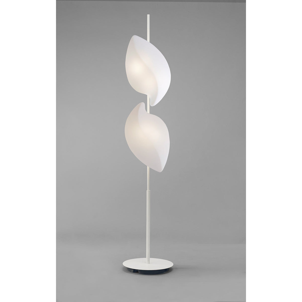 The Natura 4 Light Outdoor Floor Lamp in Matt White/Opal White features two leaf-shaped lampshades arranged vertically on a slim stand with a round base, creating sculptural lighting against a neutral gray background.