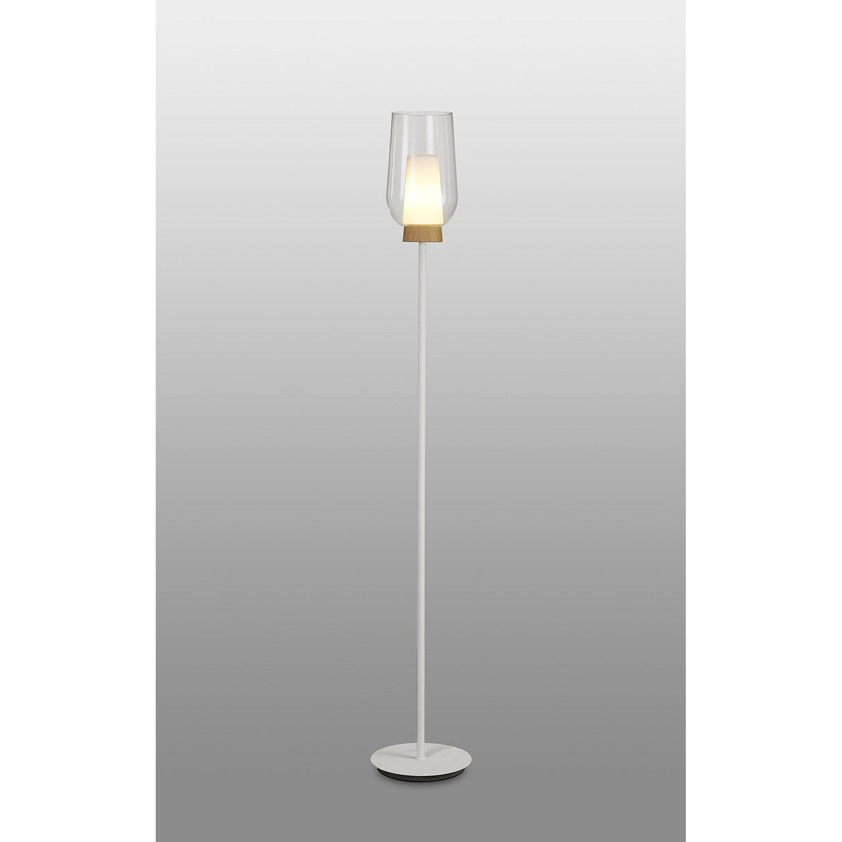 The Nora 1 Light Clear Glass Floor Lamp in white features a circular base, slender pole, wood-accented clear glass shade, and emits gentle Scandinavian light against a gray gradient backdrop.