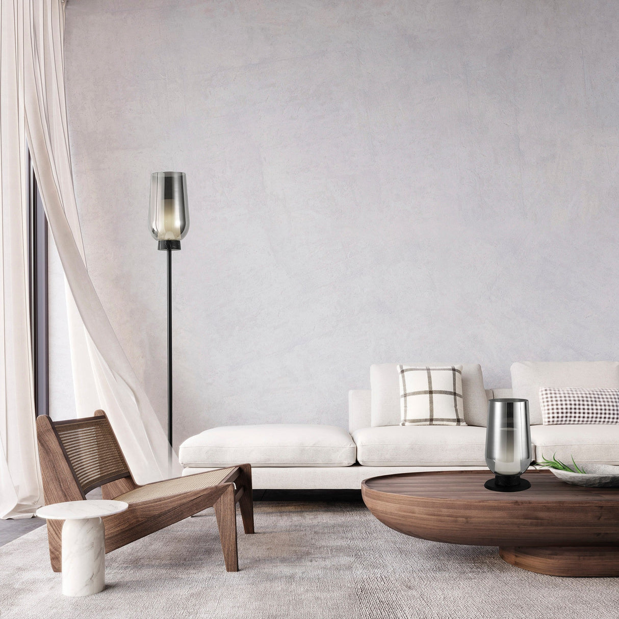 A modern living room with a white sofa, wooden coffee table, wooden chair with white cushion, Nora 1 Light Chrome Glass Floor Lamp - Black & Black Marble, small table lamp, light curtains, and checkered pillow.