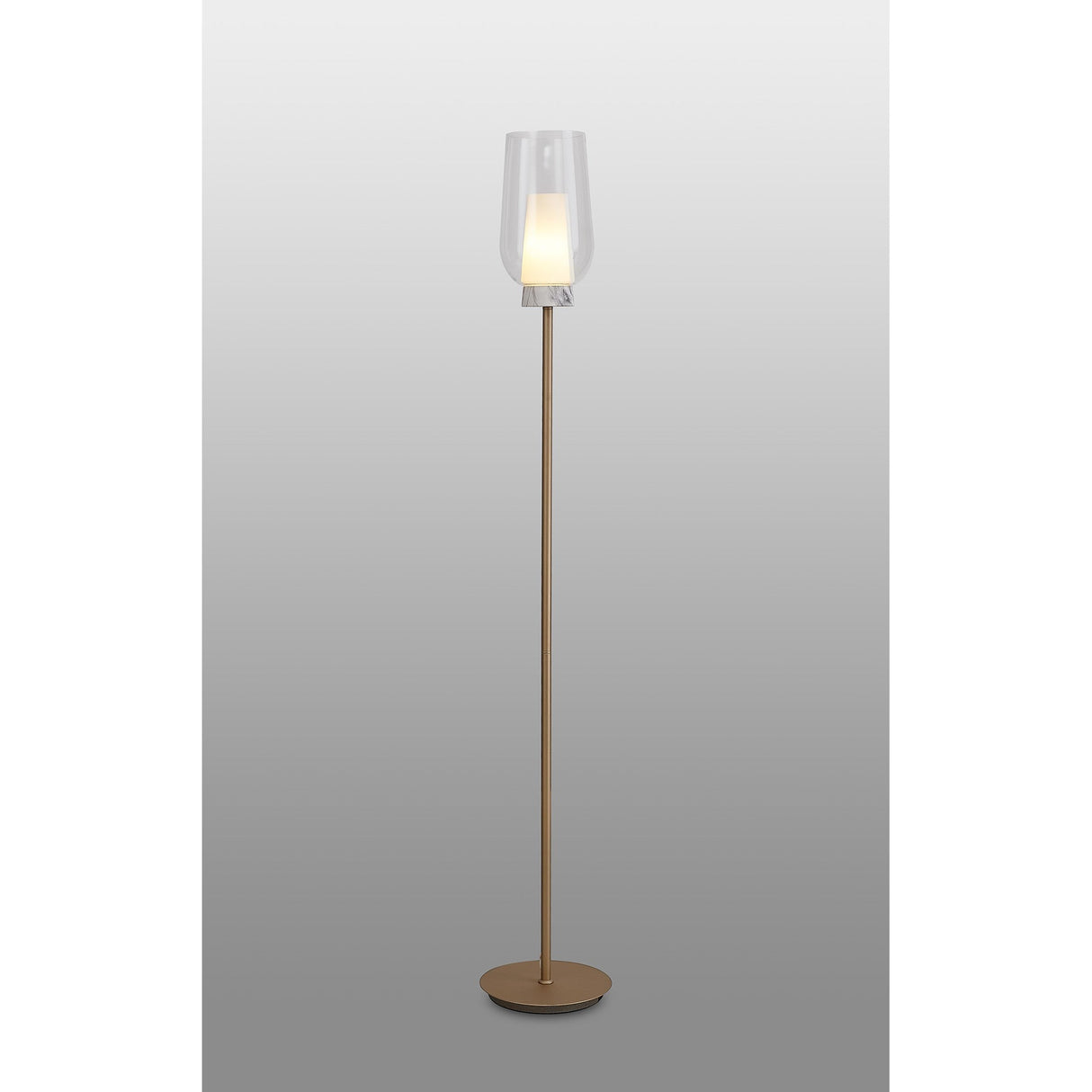 The Nora 1 Light Clear Glass Floor Lamp features a slim gold and white stand with a round base, topped by a clear glass shade that softly glows, adding elegant modern lighting to your space.