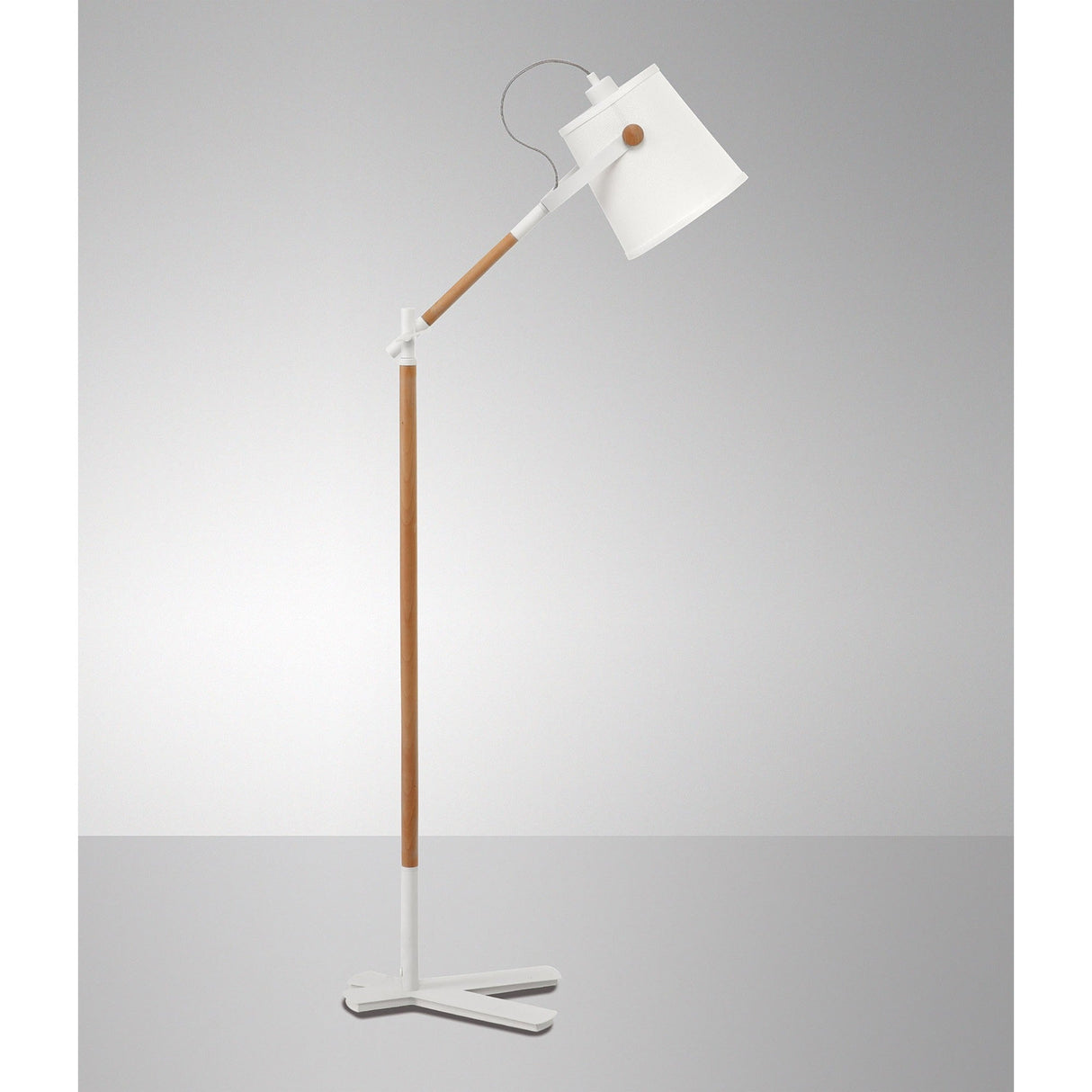 The Nordica 1 Light Floor Lamp in matt white with an ivory white shade features wooden accents and adds subtle Scandinavian style against a plain gray background.