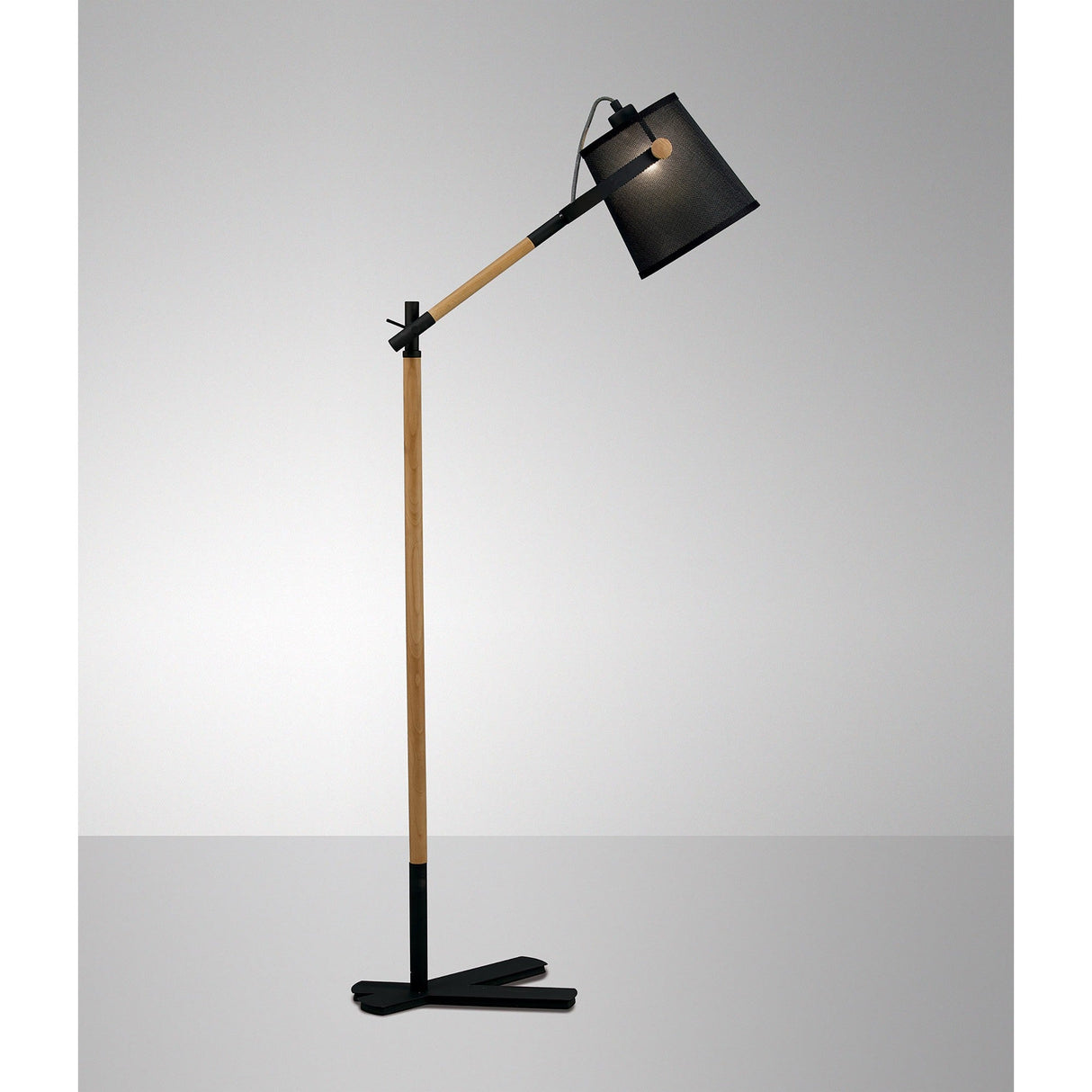 The Nordica 1 Light Floor Lamp features a modern adjustable design with a wooden stand, matt black metal base, and matching black shade, shown against a plain gray background.