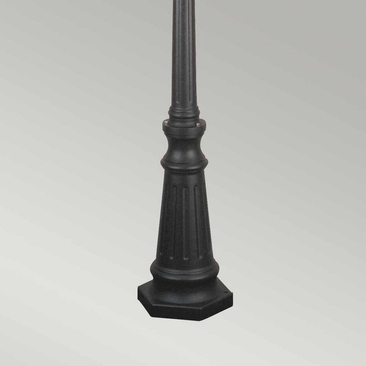 A close-up of the Norfolk 3 Light Lamp Post - Black highlights its ornate, fluted base with traditional design elements. The hexagonal outdoor lighting feature is displayed against a plain, light gray background.