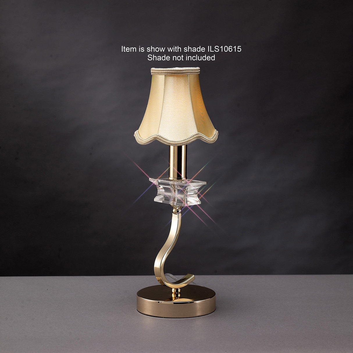 The Nydia 1 Light Crystal Table Lamp in French Gold features a curved base and decorative glass accent under the bulb, shown with a light-colored lampshade. Note: Lampshade not included.