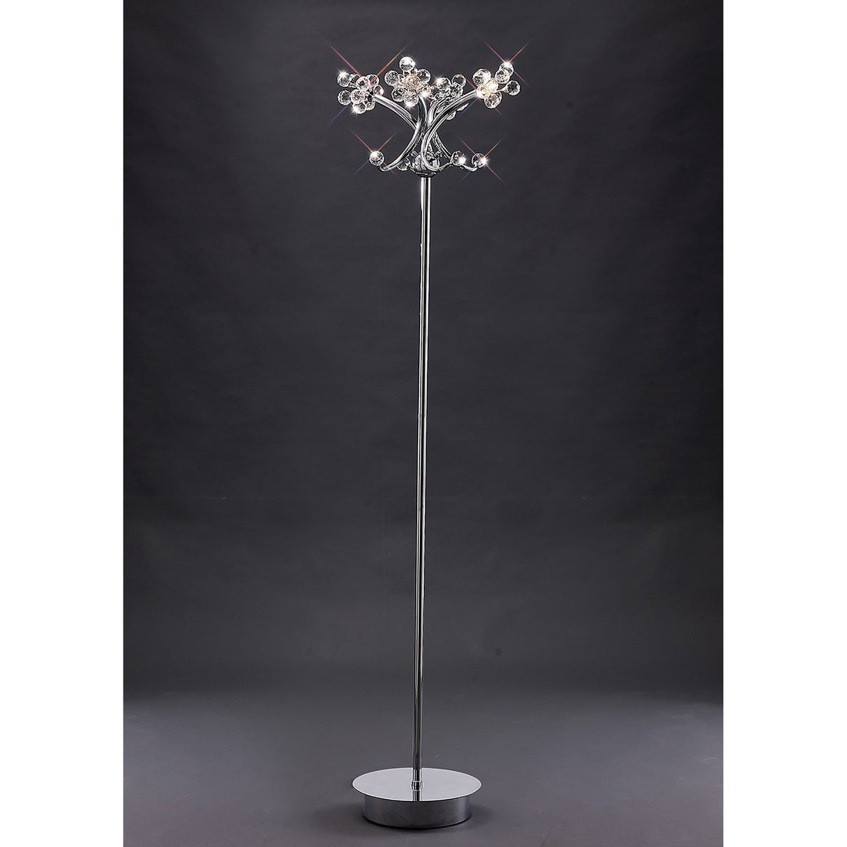 The Octavia 4 Light Crystal Floor Lamp in polished chrome features crystal-like accents, a round base, and decorative top to provide ambient lighting—perfect for adding elegance against a dark background.