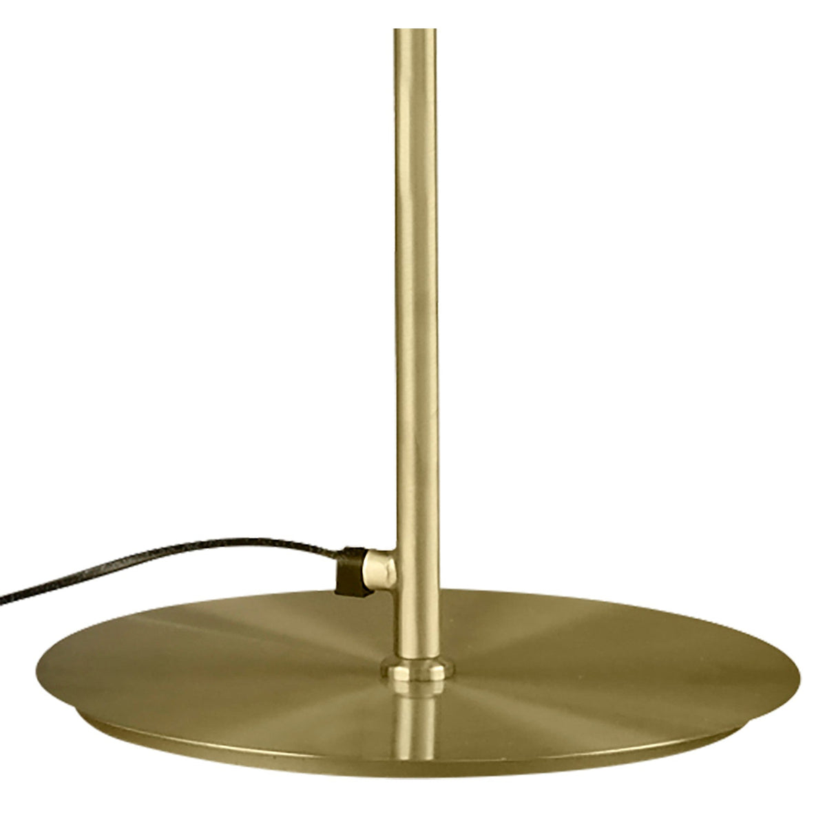 A close-up of the Olimpia LED Floor Lamp 12W 3000K in satin gold shows its brushed brass base with a flat circular design and a black power cord, highlighting modern minimalism against a plain white background.