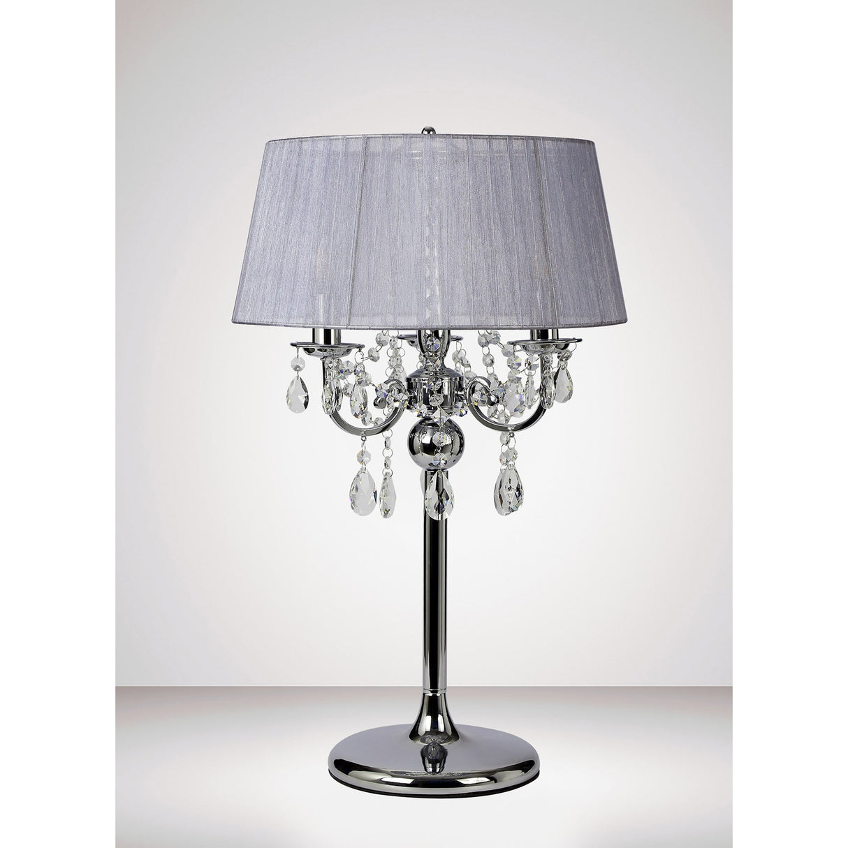 The Olivia 3 Light Crystal Table Lamp features a polished chrome finish, sparkling crystal accents, and a grey shade, providing elegant ambient lighting with its shiny round base.