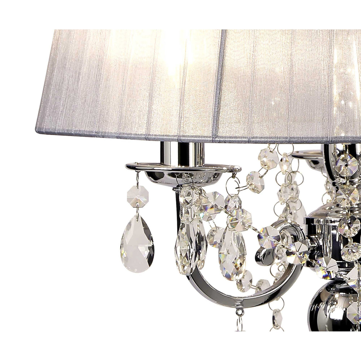 Close-up of the Olivia 3 Light Crystal Table Lamp in chrome with a grey shade, featuring polished arms and crystal pendants that reflect light for added sparkle, elegance, and ambient illumination.