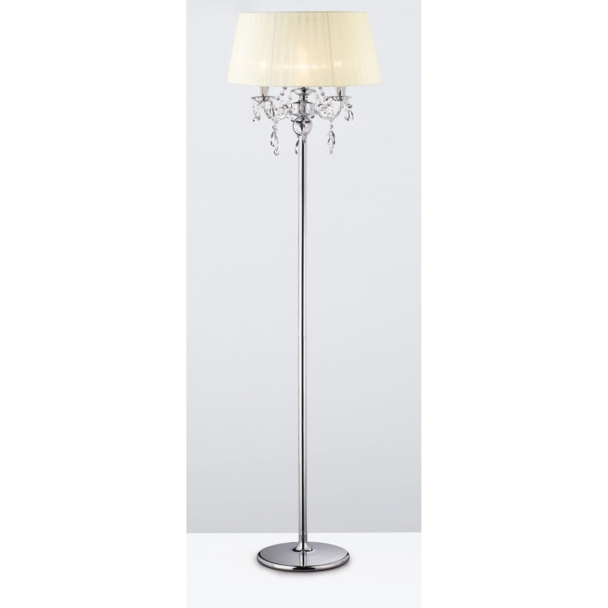 The Olivia 3 Light Crystal Floor Lamp in chrome features a cream pleated shade, hanging crystal accents, and a round base with a tall stand, shown against a plain white background.