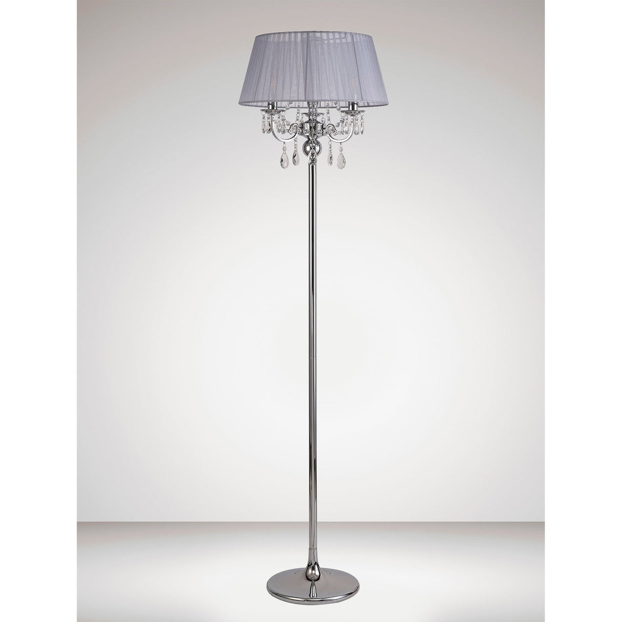 The Olivia 3 Light Crystal Floor Lamp features a chrome base, a grey pleated shade, and hanging crystal ornaments. This modern lamp brings elegance to any space with its sophisticated design.