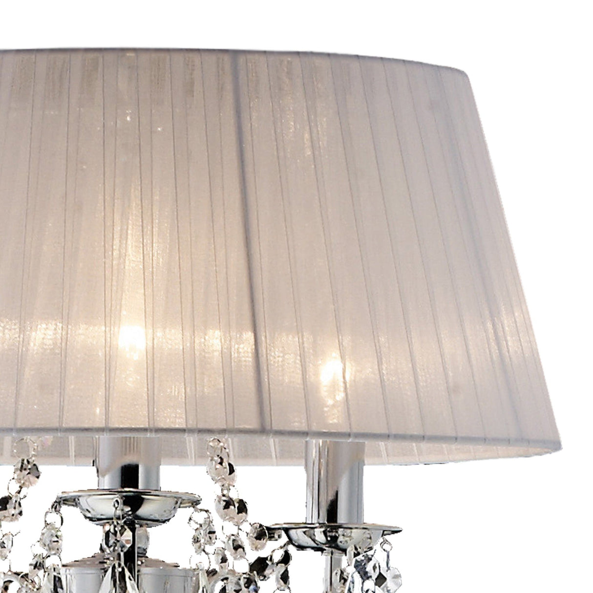 A close-up of the Olivia 3 Light Crystal Floor Lamp in chrome with a large, pleated white shade and crystal accents. The dimmable lamp is illuminated, casting a soft glow.