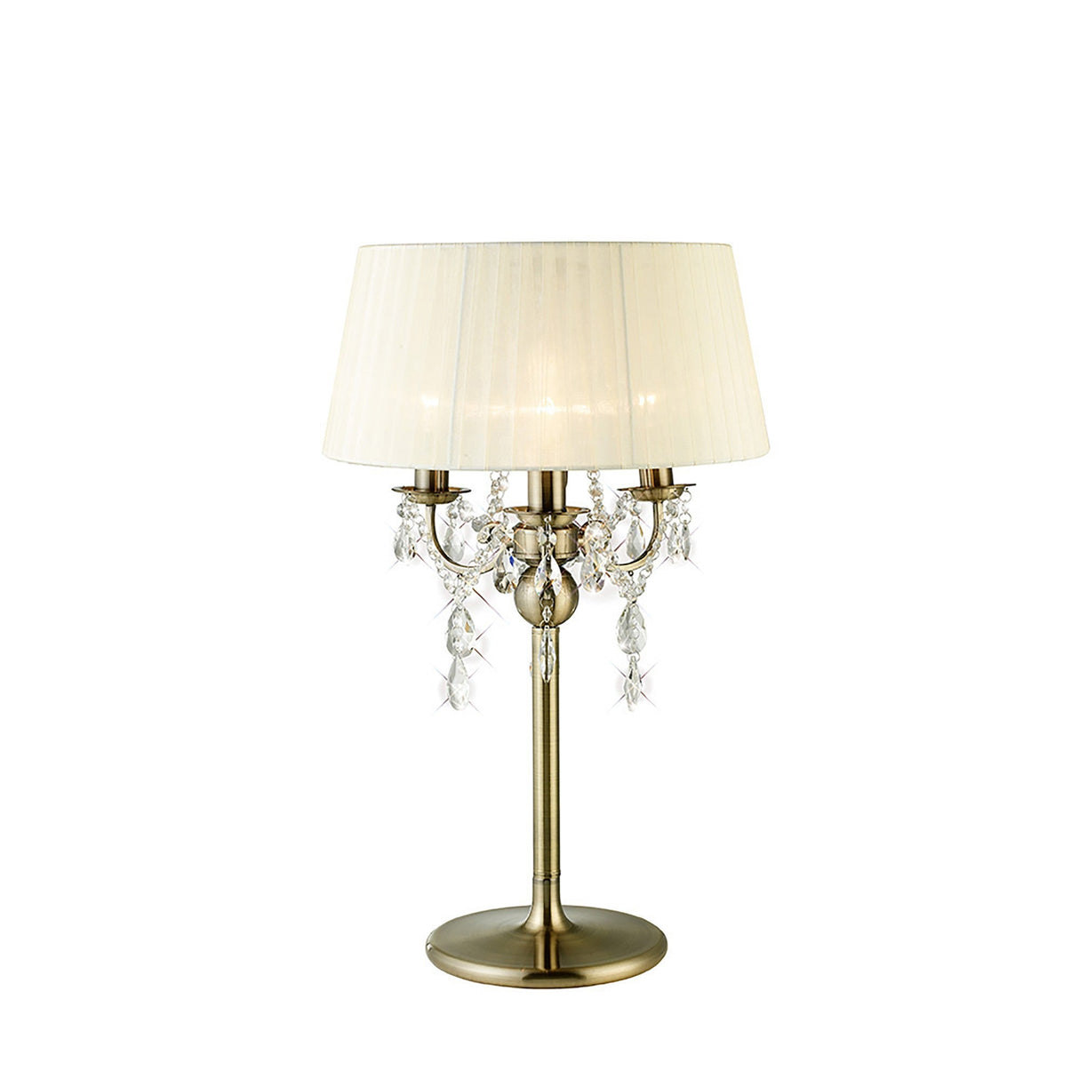 The Olivia 3 Light Crystal Table Lamp features an antique brass base, three candle-style lights, hanging crystal ornaments, and a pleated cream shade. Its Flemish-inspired design brings classic elegance to any space.