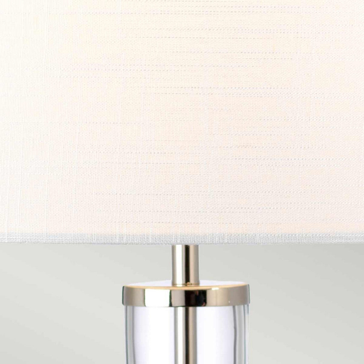 Close-up of the Orb 1 Light Table Lamp featuring a polished nickel base and a white shade. The neutral color palette creates a modern and minimalist look.