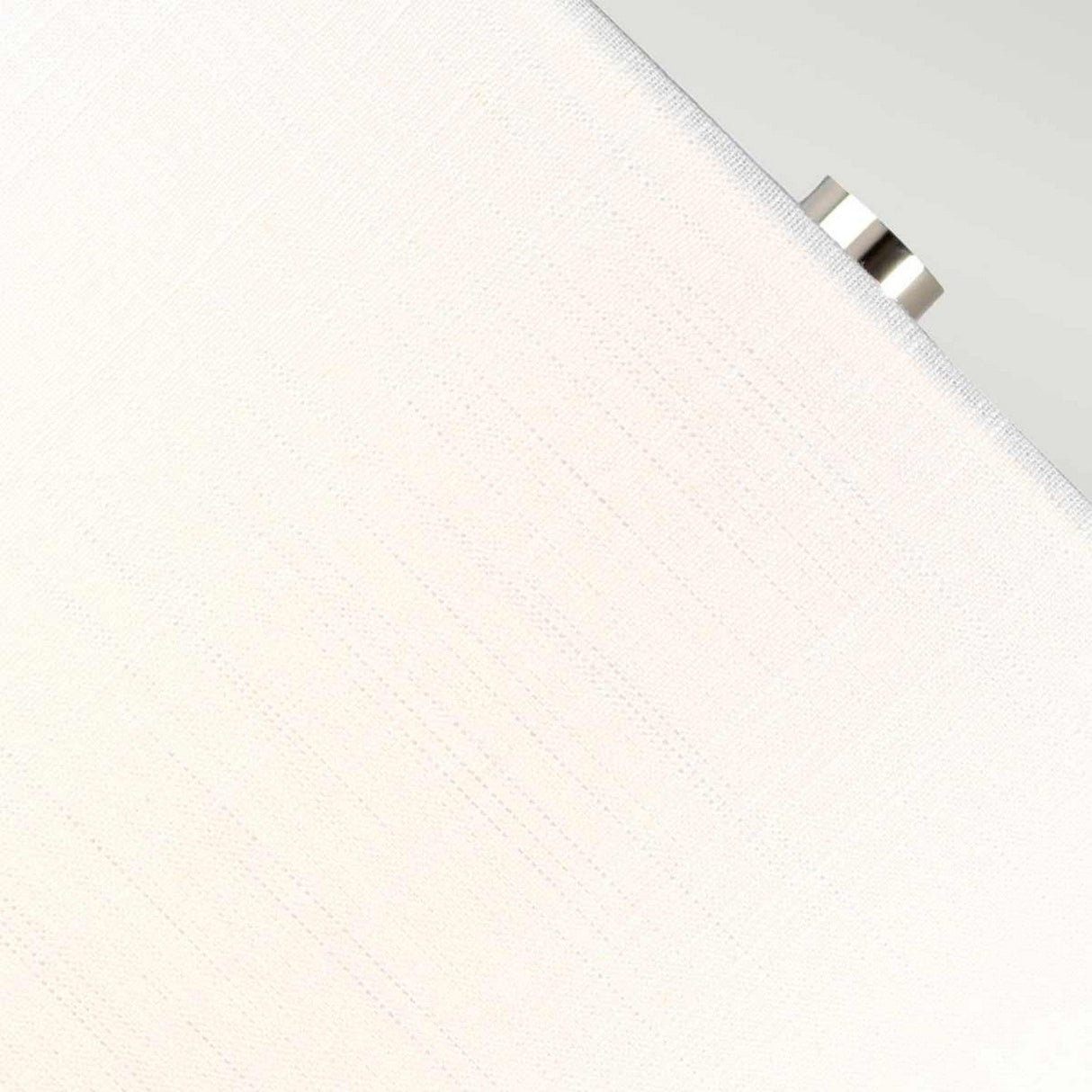 A detailed view reveals the textured white shade of the Orb 1 Light Table Lamp with a small polished nickel knob adorning its side. The surface showcases a delicate linear pattern, set against a soft gray backdrop that enhances the lamp's elegantly simple design.