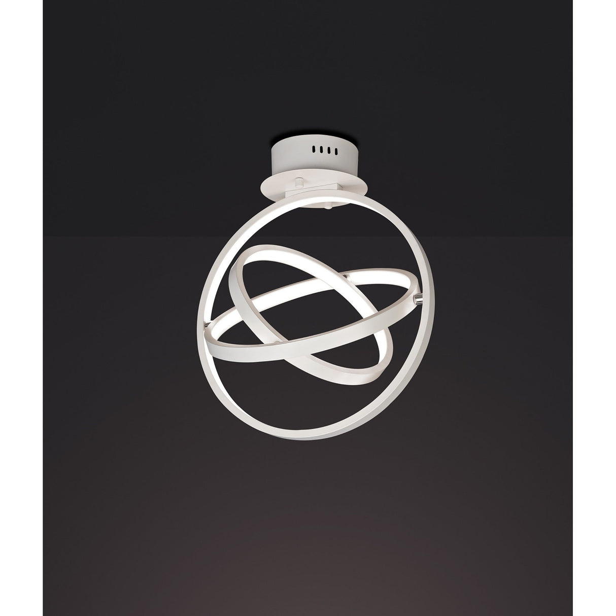 Mantra Orbital LED semi-flush ceiling light with three interlocking matt white aluminium rings in a spherical form, shown against a dark background.
