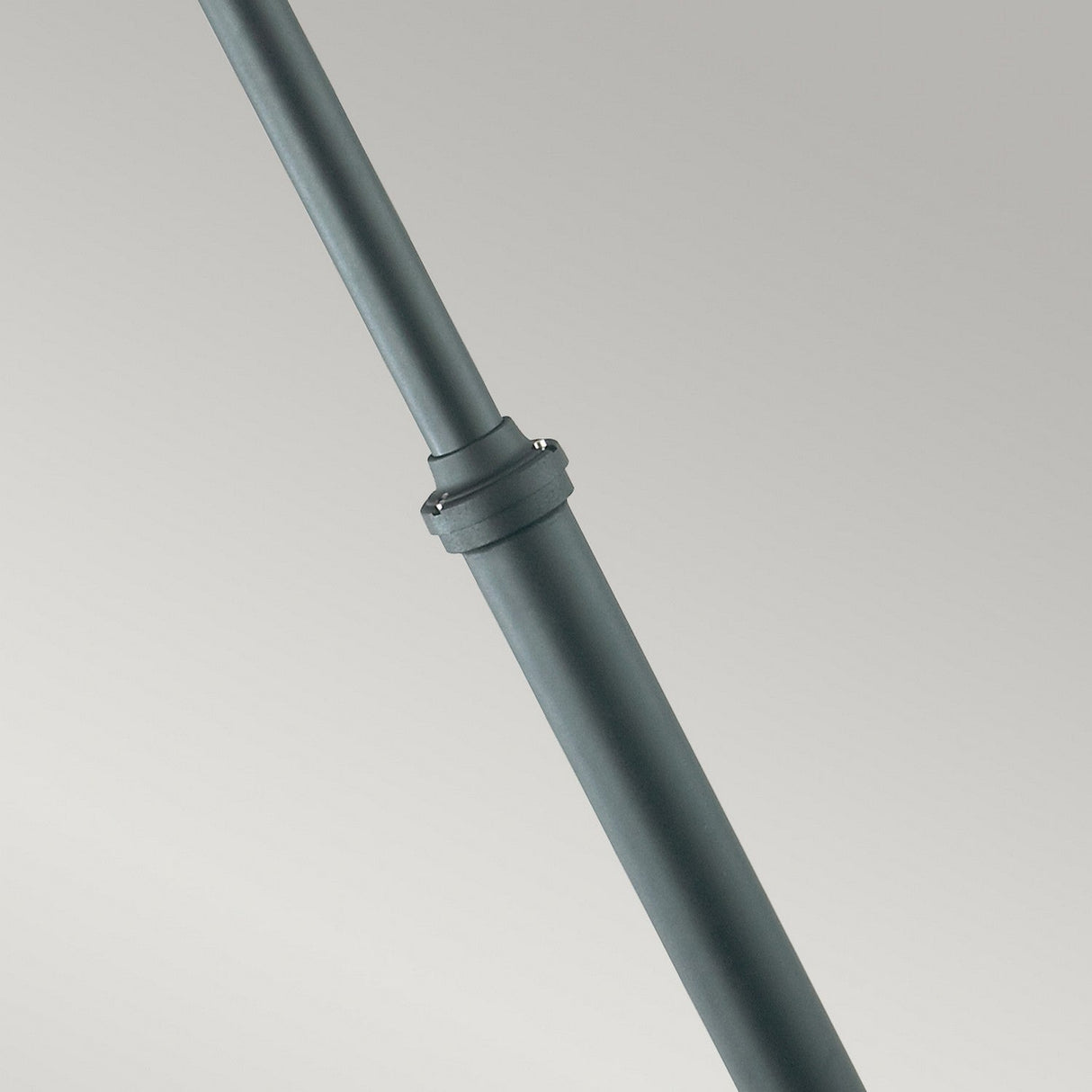 Close-up of an Oslo 2 Light Lamp Post - Black, featuring a visible joint against a light gray background. The galvanization offers durability, and the pole is positioned diagonally from the top left to the bottom right corner of the image, emphasizing its sturdy design for exterior lighting solutions.