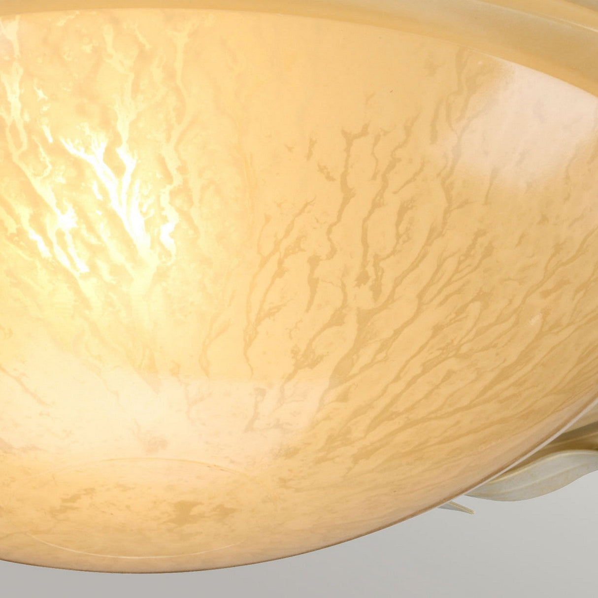 Detailed view of the Olivia 1 Light Flush lampshade, showcasing its textured, handmade craftsmanship with a soft yellowish glow. The marbled pattern, enriched by an ivory/gold patina, lends a warm and inviting appearance.