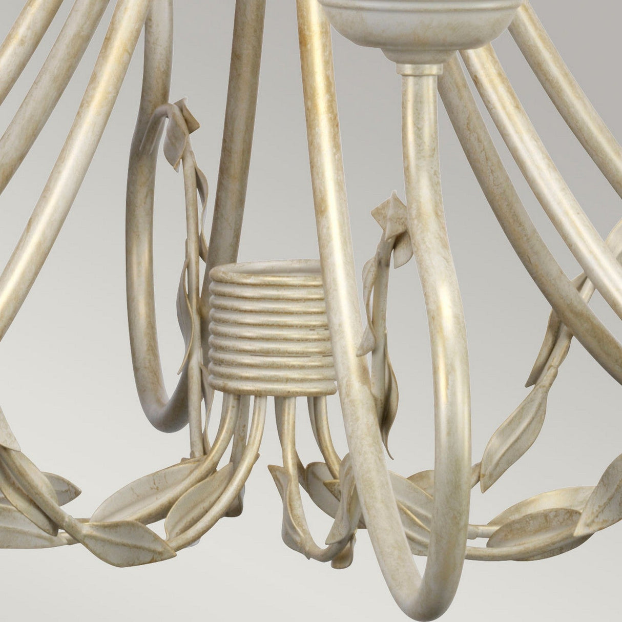 Close-up of the elegant Olivia 8 Light Chandelier, showcasing its handmade vintage design. It features smooth, curved metal arms and leaf-like decorations adorned in an ivory/gold patina finish, set against a neutral background.