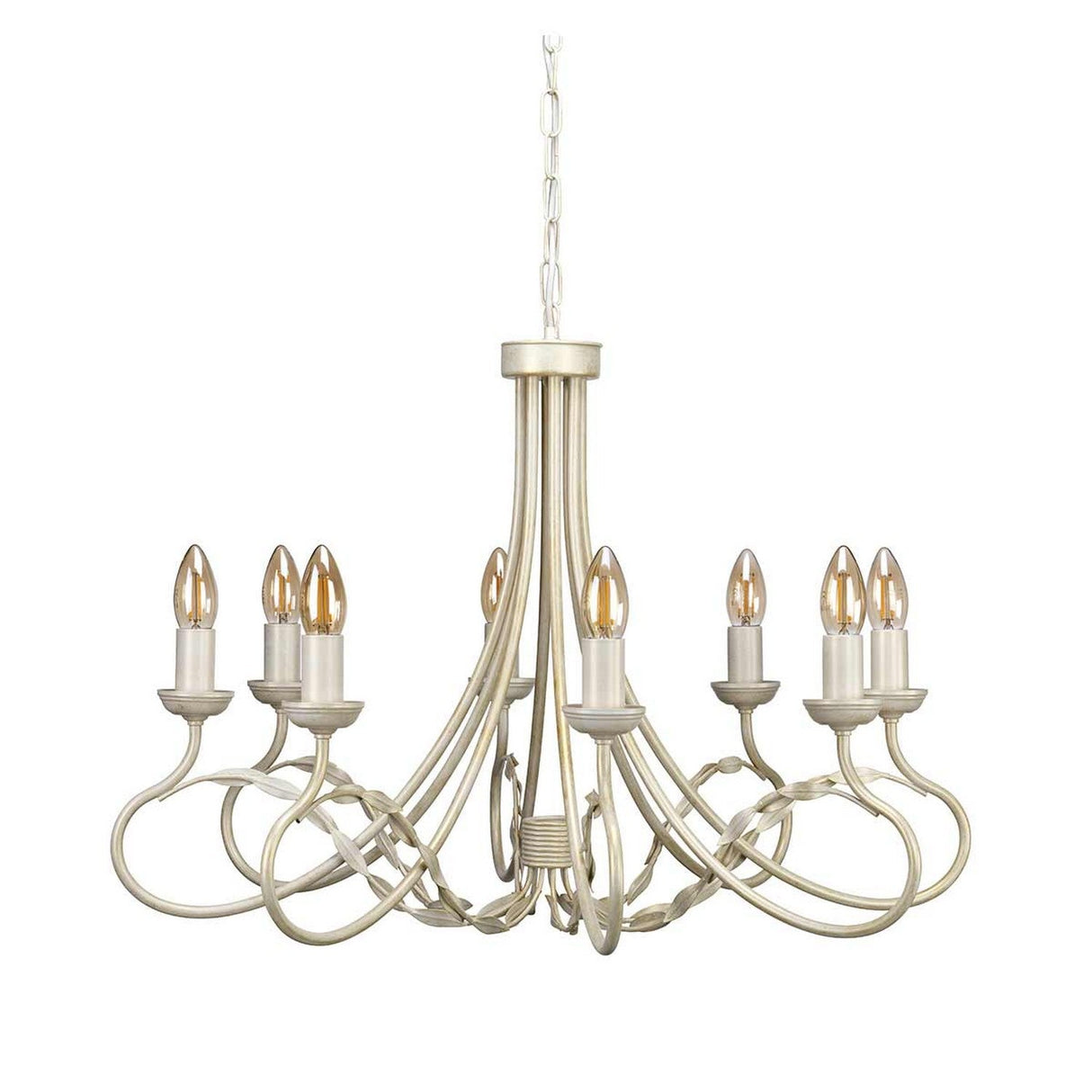 The Olivia 8 Light Chandelier - Ivory/Gold Patina is a traditional handmade chandelier with an ornate design, featuring eight candle-shaped light fixtures. It boasts an ivory finish with a touch of gold patina and intricate curved metal arms, gracefully hanging from a chain.