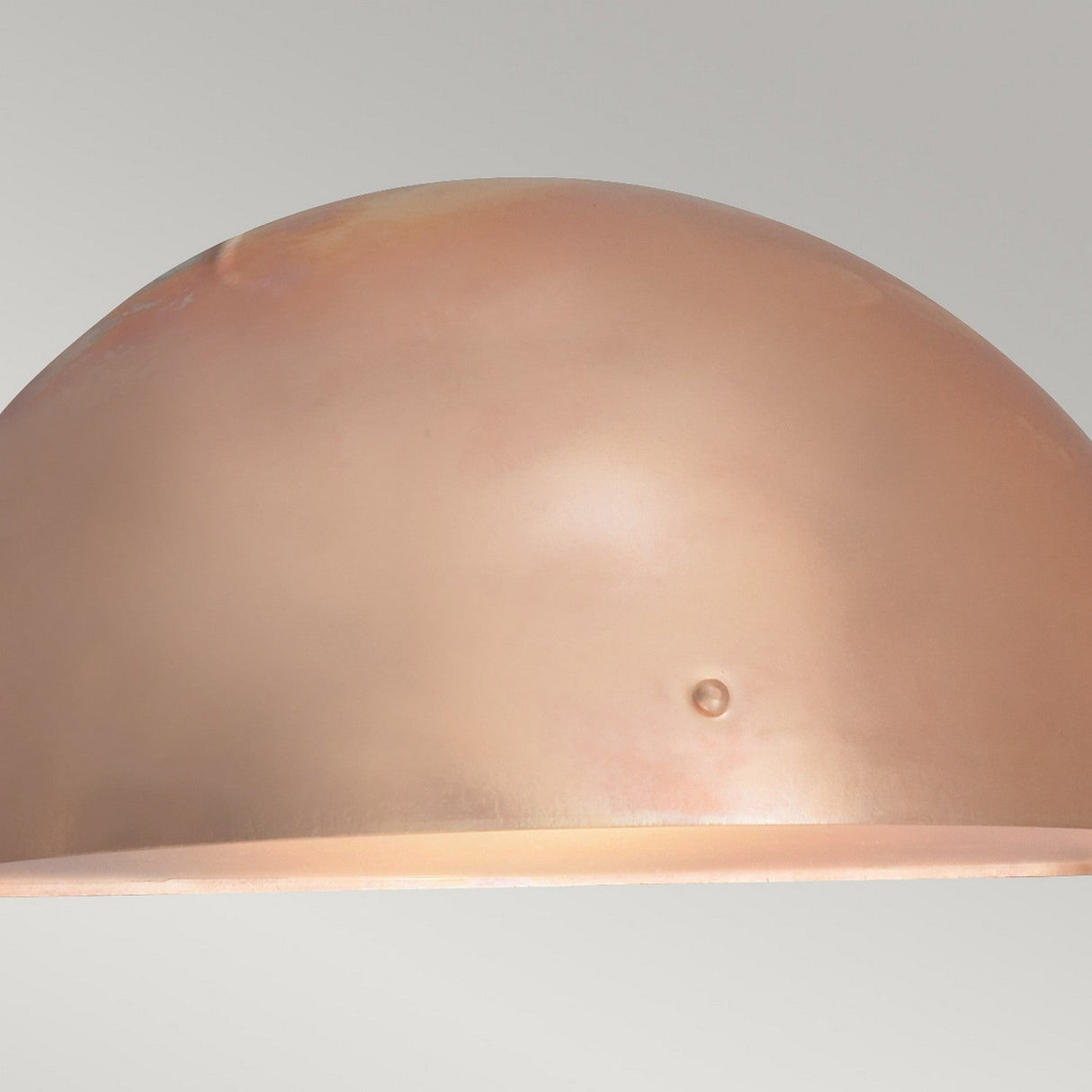 Image showcasing the Paris Outdoor Large 1 Light Wall Lantern in copper, featuring a smooth, dome-shaped design against a light gray background. The lantern's surface has a subtle shine with a small indentation near the center, making it ideal for outdoor lighting.