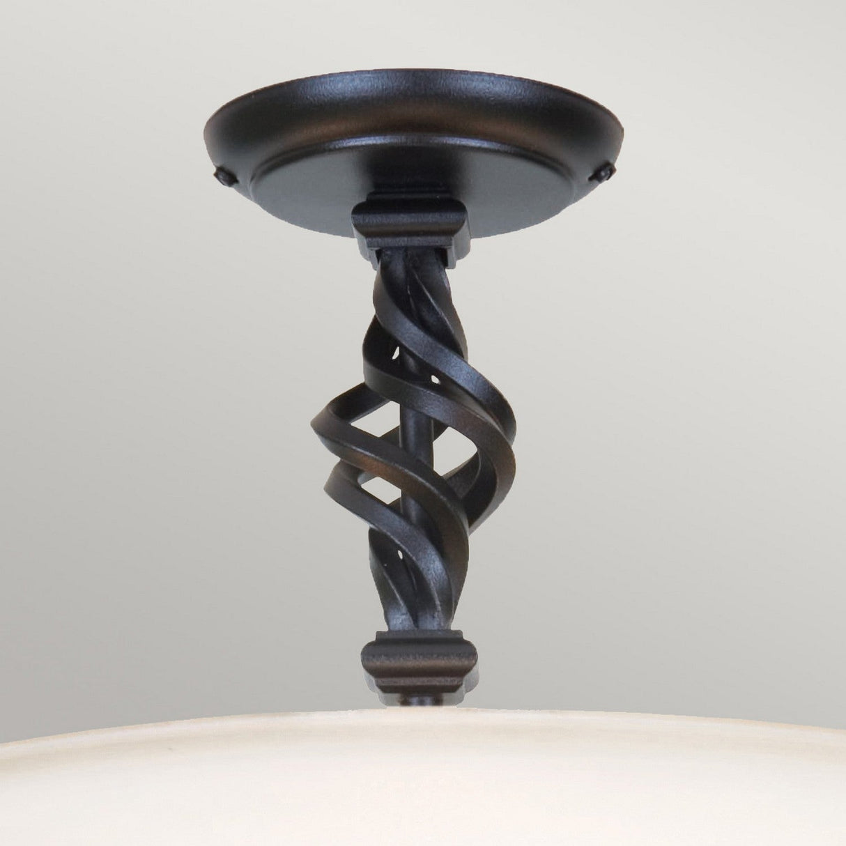 Introducing the Pembroke 3 Light Semi Flush in Black, this piece exemplifies traditional craftsmanship with its twisted metal design in a dark finish. Hand-forged iron elegantly encircles the circular base, allowing the light shade to discreetly peek through at the bottom.