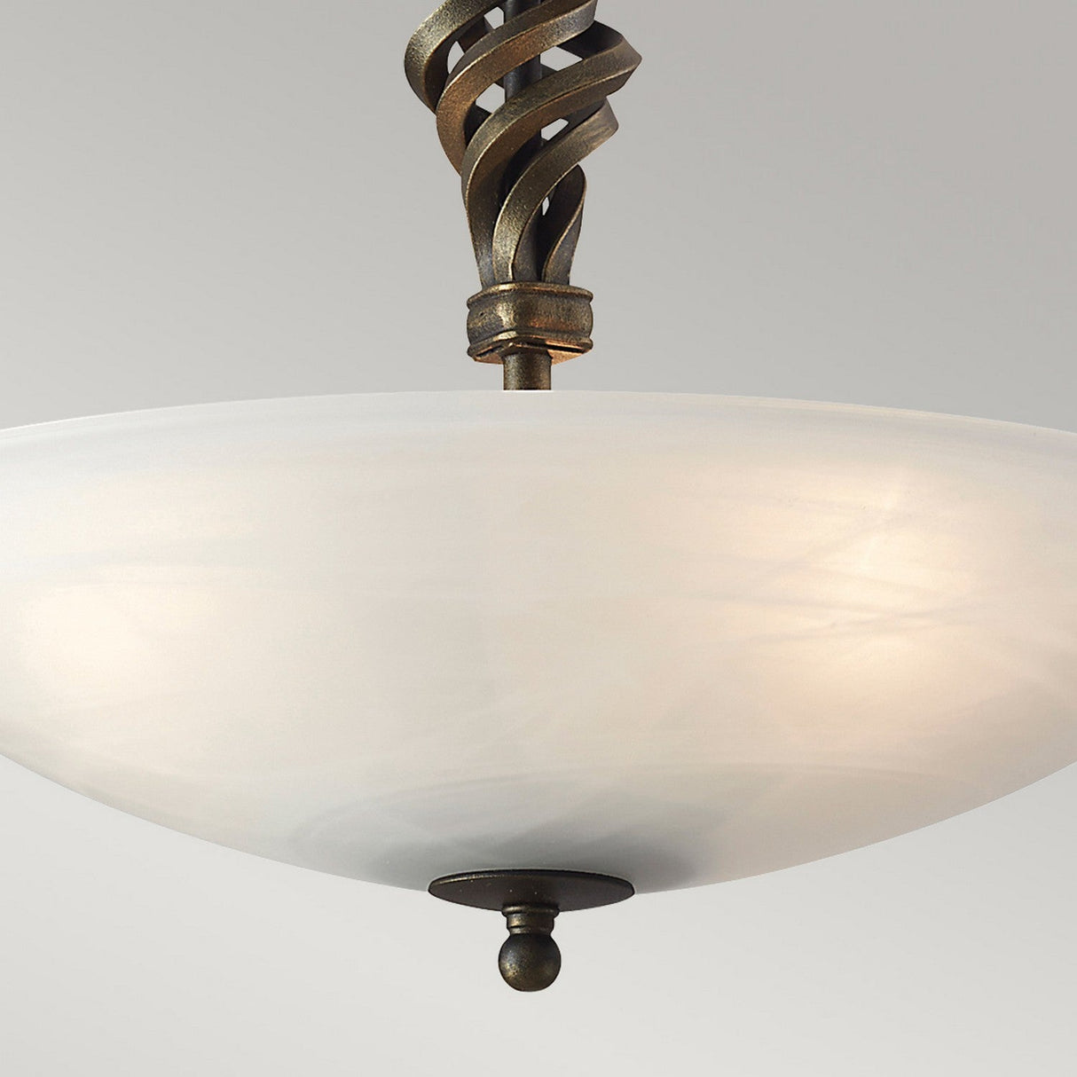 A detailed view of the Pembroke 3 Light Semi Flush, showcasing a large, frosted white glass bowl-shaped shade. The fixture is adorned with a stylish black and gold twisted metal stem that introduces an artistic flair against a simple neutral backdrop.