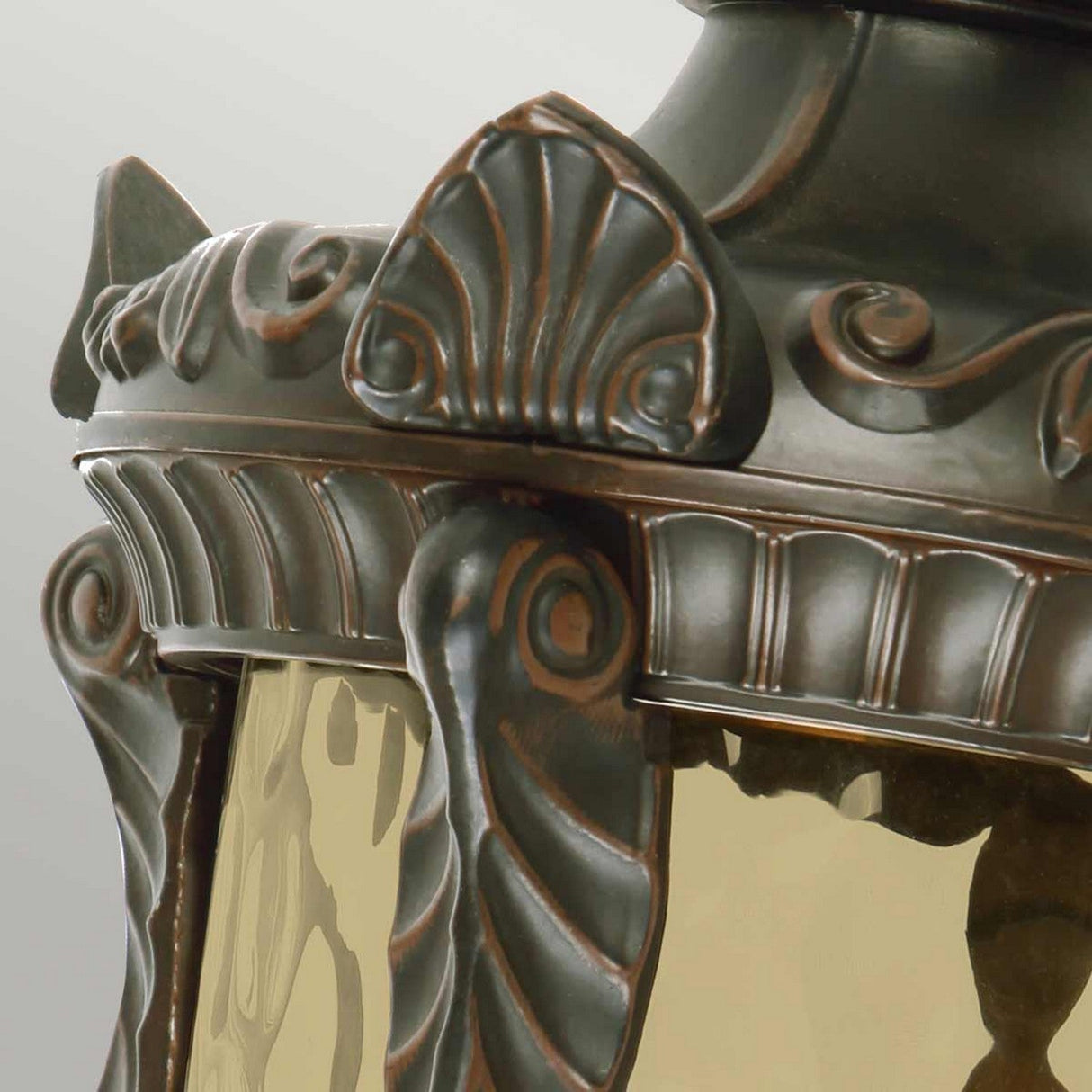 Close-up of the Philadelphia 3 Light Outdoor Large Wall Light, showcasing its ornate vintage-style design with intricate metalwork details, including scrolls and shell motifs. This lantern is finished in an old bronze hue and features glass panels for both elegance and IP44 rated protection against the elements.