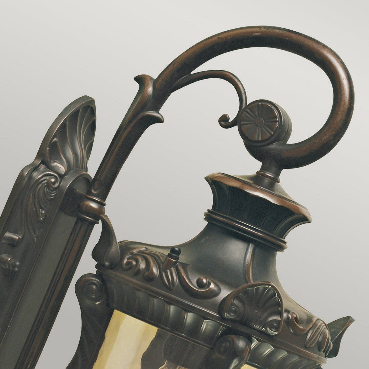 Here's a description using the provided product data:
Close-up of the Philadelphia 1 Light Outdoor Small Down Wall Light. This down wall light features elaborate metalwork with decorative scrolls and graceful curves. It has an old bronze finish that imparts a classic and antique look.