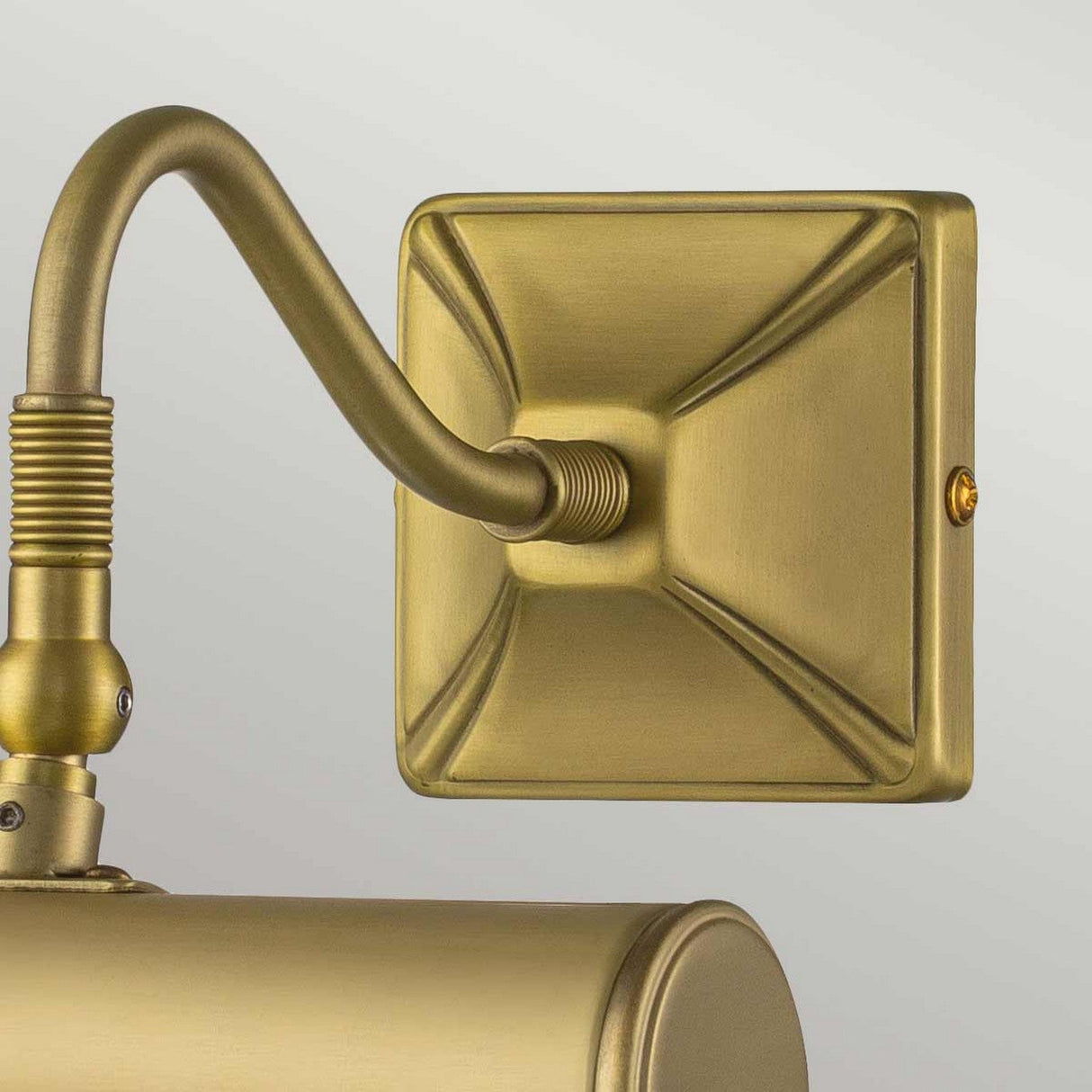 Close-up of the Picture Light 1 Light Small in brushed brass, featuring a wall-mounted design with a square base plate and adjustable arm. This fixture showcases a classic and elegant design with subtle detailing.